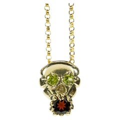 Skull and Soul (14K Yellow Gold, Peridot, and Garnet Pendant) by Ken Fury