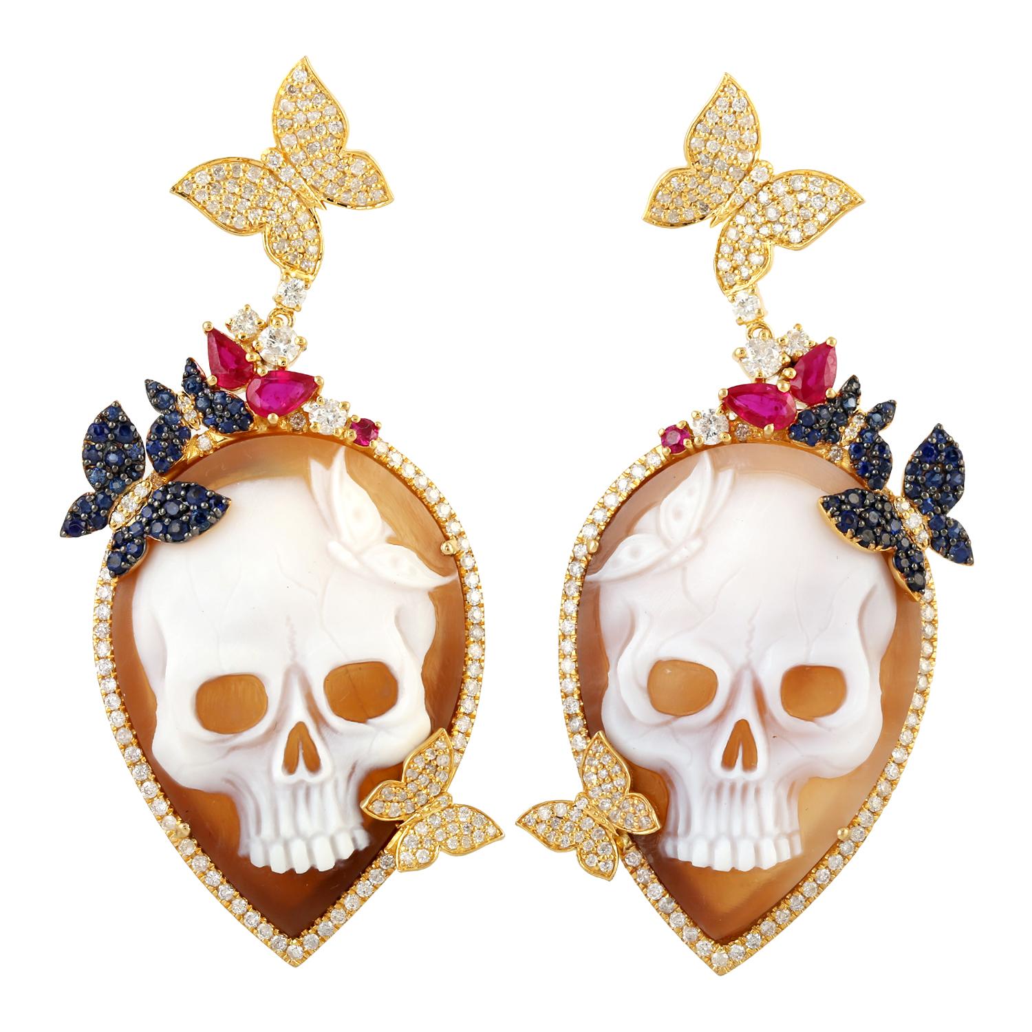 Cast in 18 karat gold. These beautiful cameo skull earrings are set Ruby, Sapphire and 2.18 carats of sparkling diamonds. 

FOLLOW  MEGHNA JEWELS storefront to view the latest collection & exclusive pieces.  Meghna Jewels is proudly rated as a Top