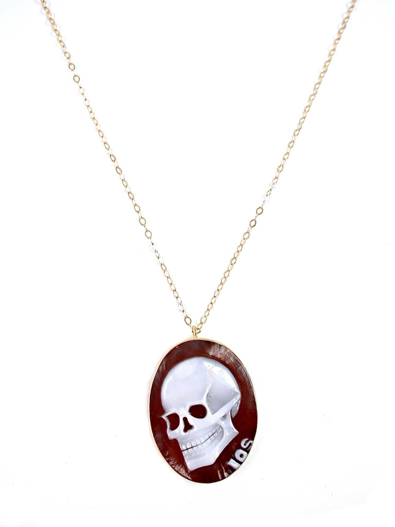Unique and unisex, the skull cameo from IOSSELLIANI has become for many a personal amulet. This magnificent oval shaped cameo is  hand carved with a skull  from Torre del Greco's artisants on a Sardonica 1st quality shell. Mounted in a 18 Carat
