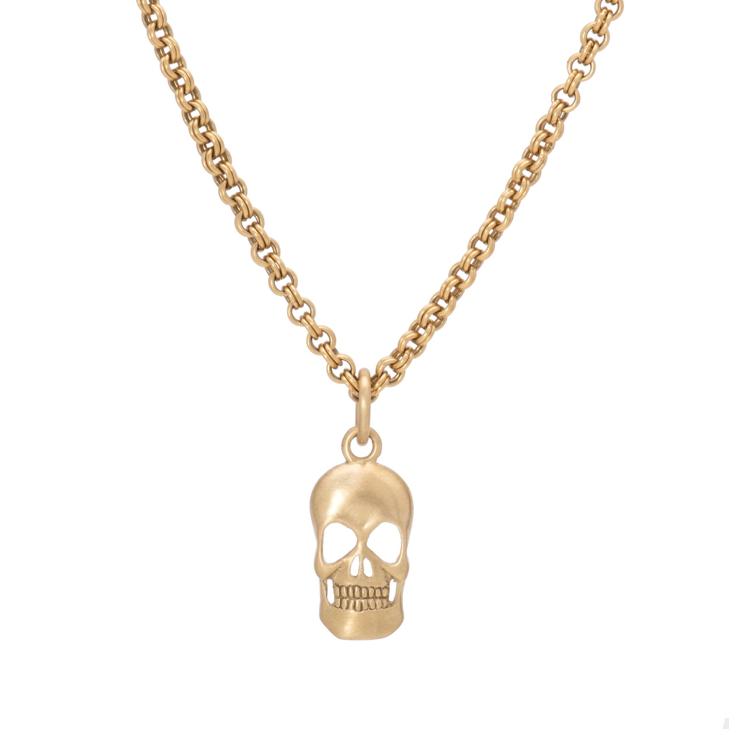 Our Skull Pendant in 18 karat gold is hand crafted in our studio with our signature satin finish offering a lustrous take on a classic. The curved form of our skull pendant reveals a 3 dimensional perspective with a stippled finish in the back. At