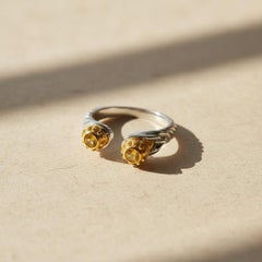 Skull ring with yellow sapphire in silver, gold