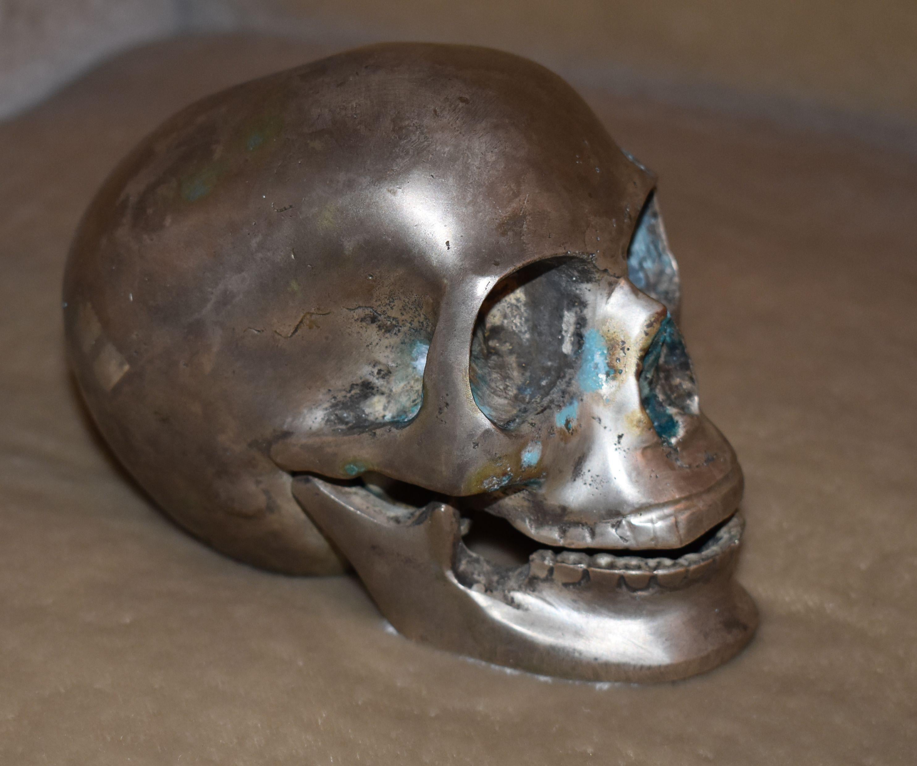Nickel-plated over bronze skull sculpture.