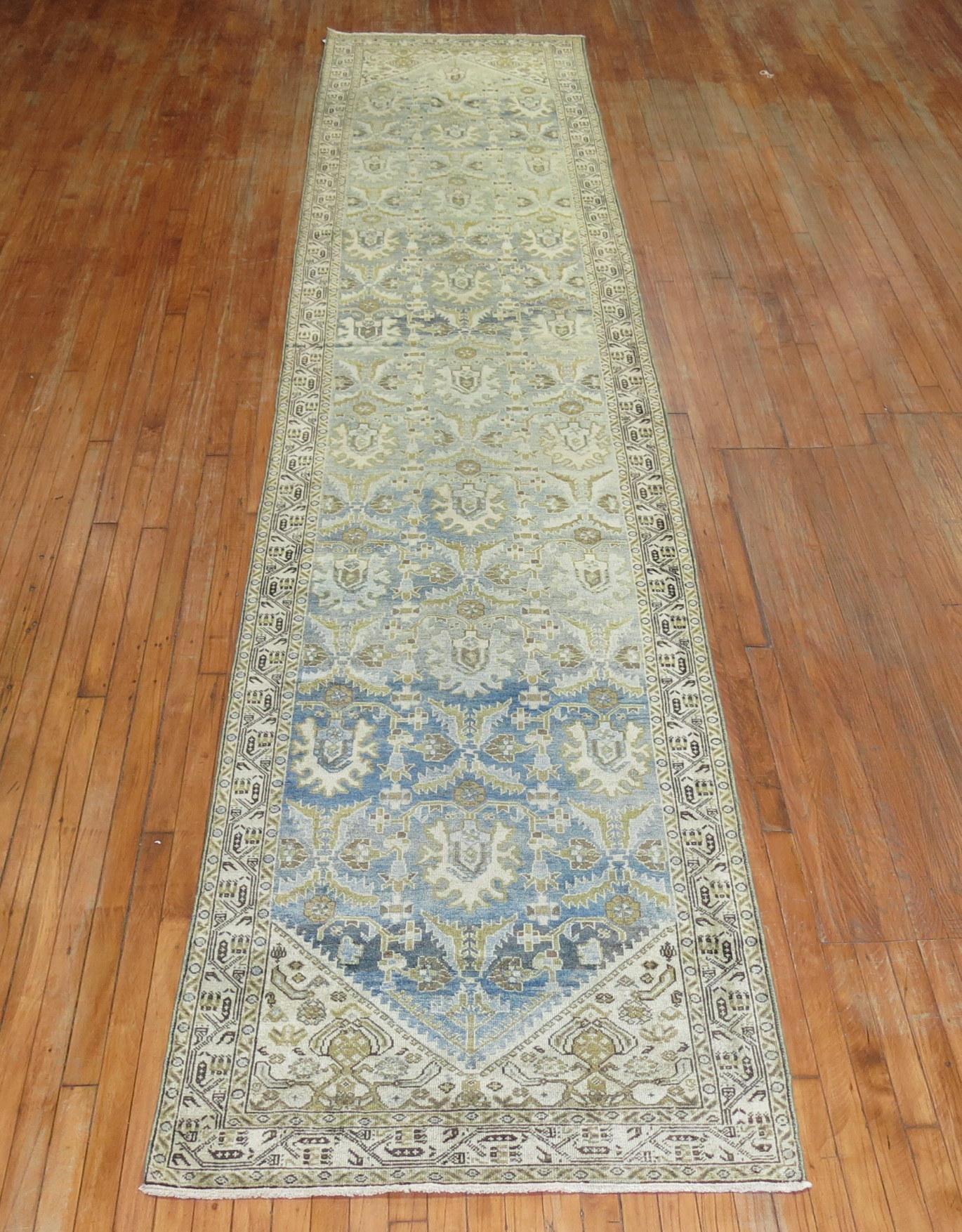 Predominant light blue Persian Malayer runner from the early 20th century. Accents in chartreuse, khaki ivory and brown.

Measures: 3'4