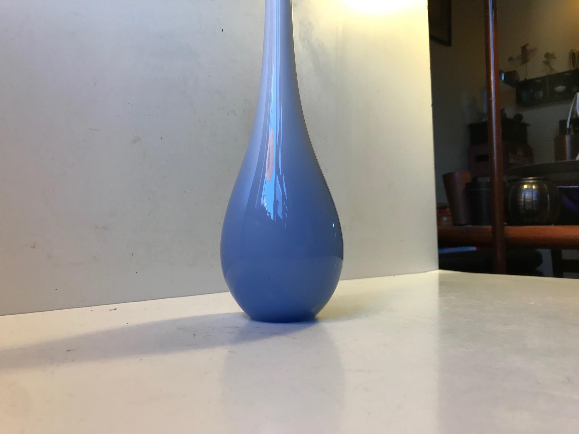 Organically shaped long and lean hand blown glass. Light blue cased opaline glass that becomes darker towards the base. It originates from Murano Italy and was manufactured during the 1960s. The design is probably by Cenedese Vetri and a unique