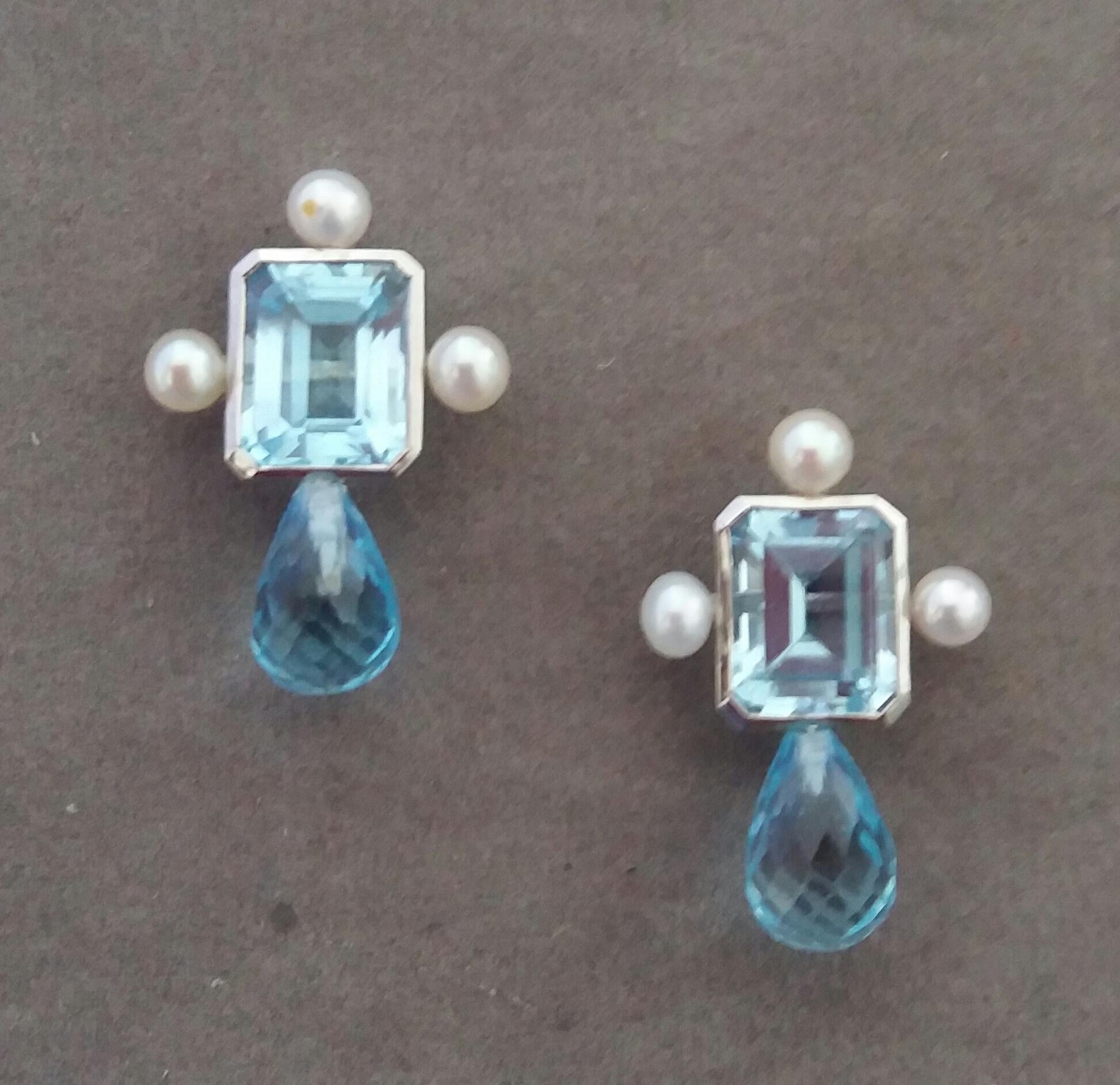 These elegant and handmade earrings have 2 Octagon Faceted Sky Blue Topaz measuring 9 x 11 mm set in a 14 Kt white gold bezel with 3 small round pearls of 4mm on 3 sides at the top to which are suspended 2 Round Drops Faceted Sky Blue Topaz