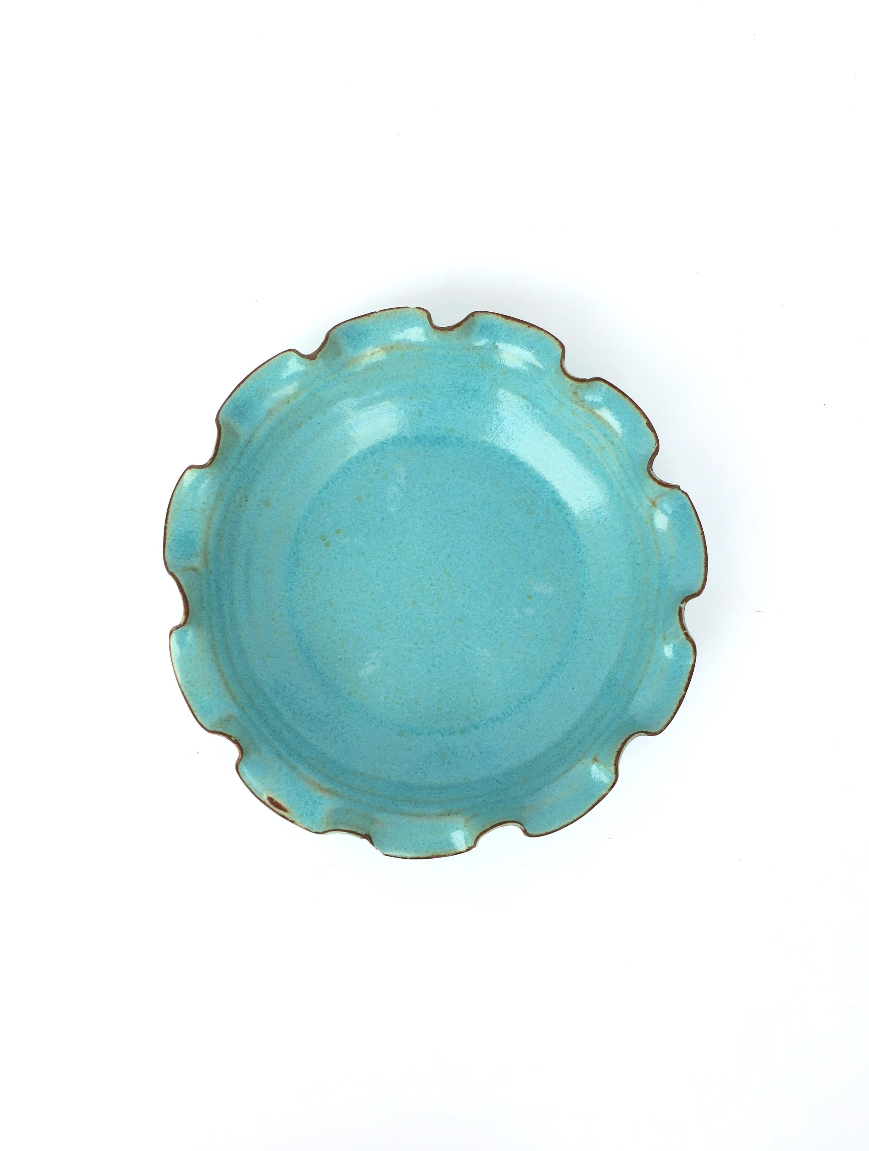 A beautiful sky-blue or turquoise blue pottery bowl with ruffled edge. Great as a standalone piece, as a catch-all, or serving bowl. Dimensions: 9.88