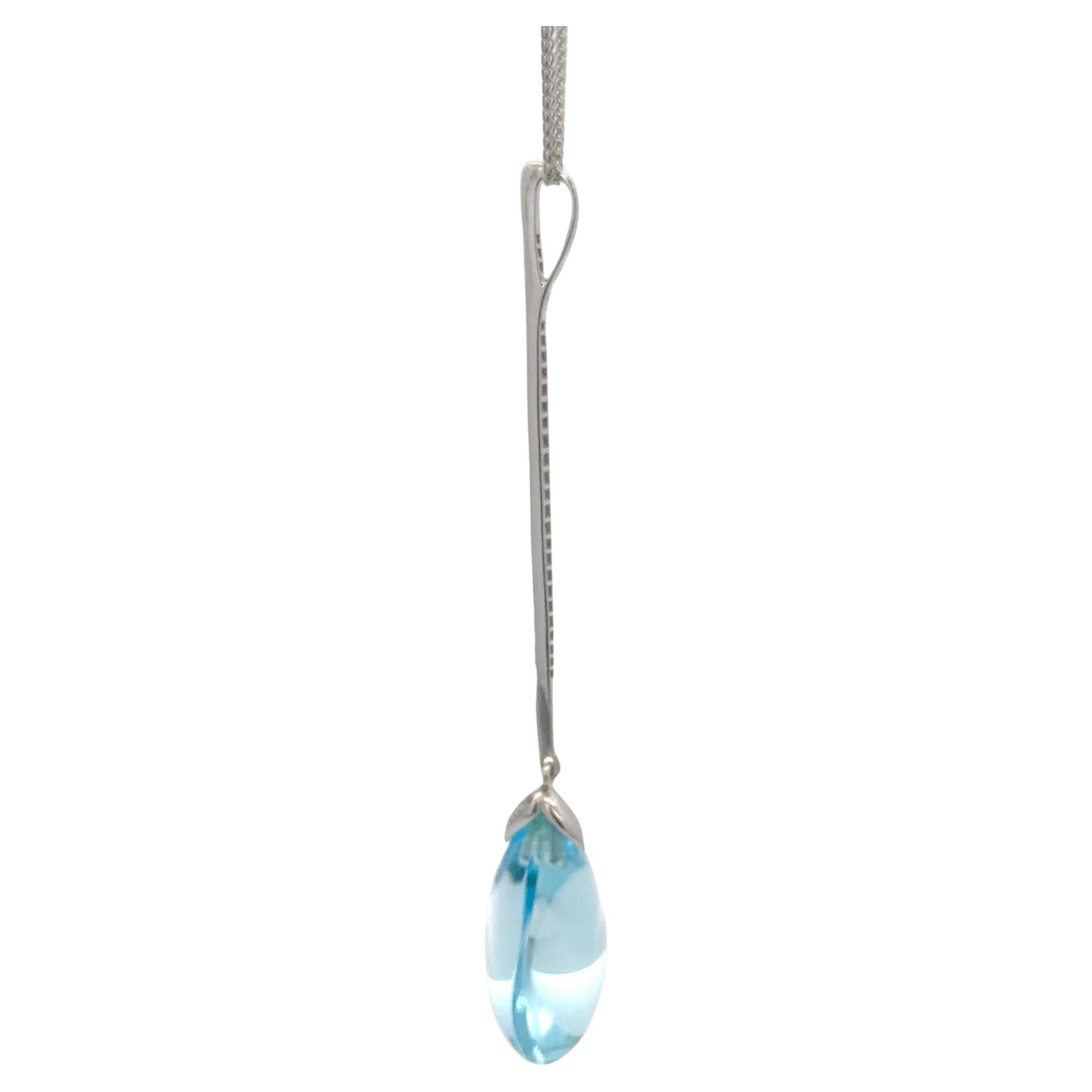 18 Karat white gold chain pendant featuring one pear shape Sky Blue Topaz weighing 13.41 carats with a diamond bar of 38 round brilliants, 0.13 carats.
Pendant measures: 2.30 inches long
