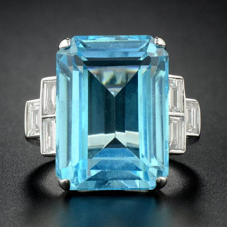 A large special size Octagon 18x13 mm. 
Sky Blue Topaz (21.94 Carat) set on a gorgeous Art Deco Sky Blue Topaz Diamond cocktail ring. 
Accented on each side with a trio of Rectangular Diamonds' twinkling. 
They are crafted in 10 Karat White Gold.