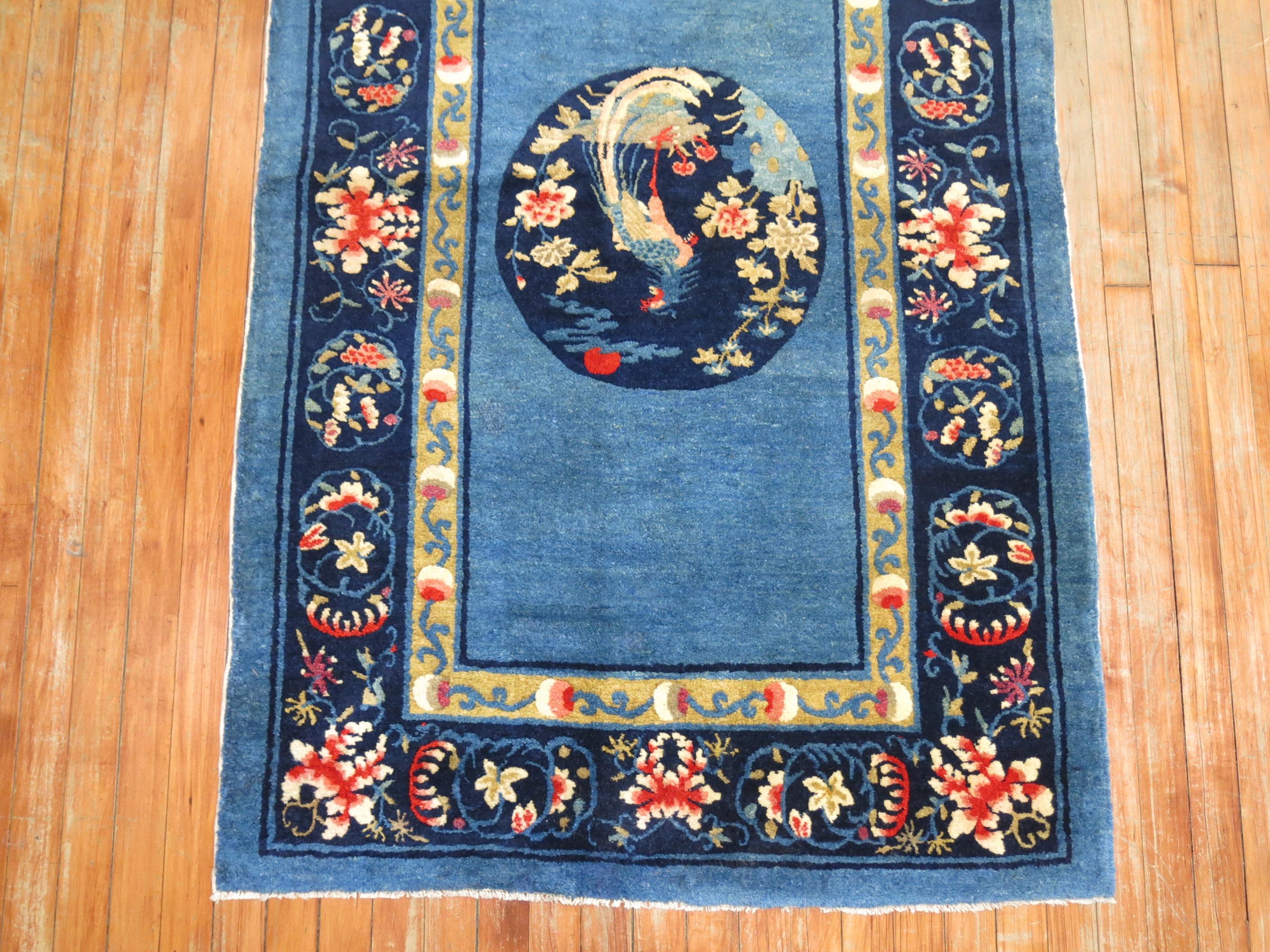 Stunning sky blue and ivory, navy accent full pile condition antique Chinese Peking rug, circa 1920. Floral border with what looks to be a rooster on a circular medallion.

Measures: 3'3'' x 5'1