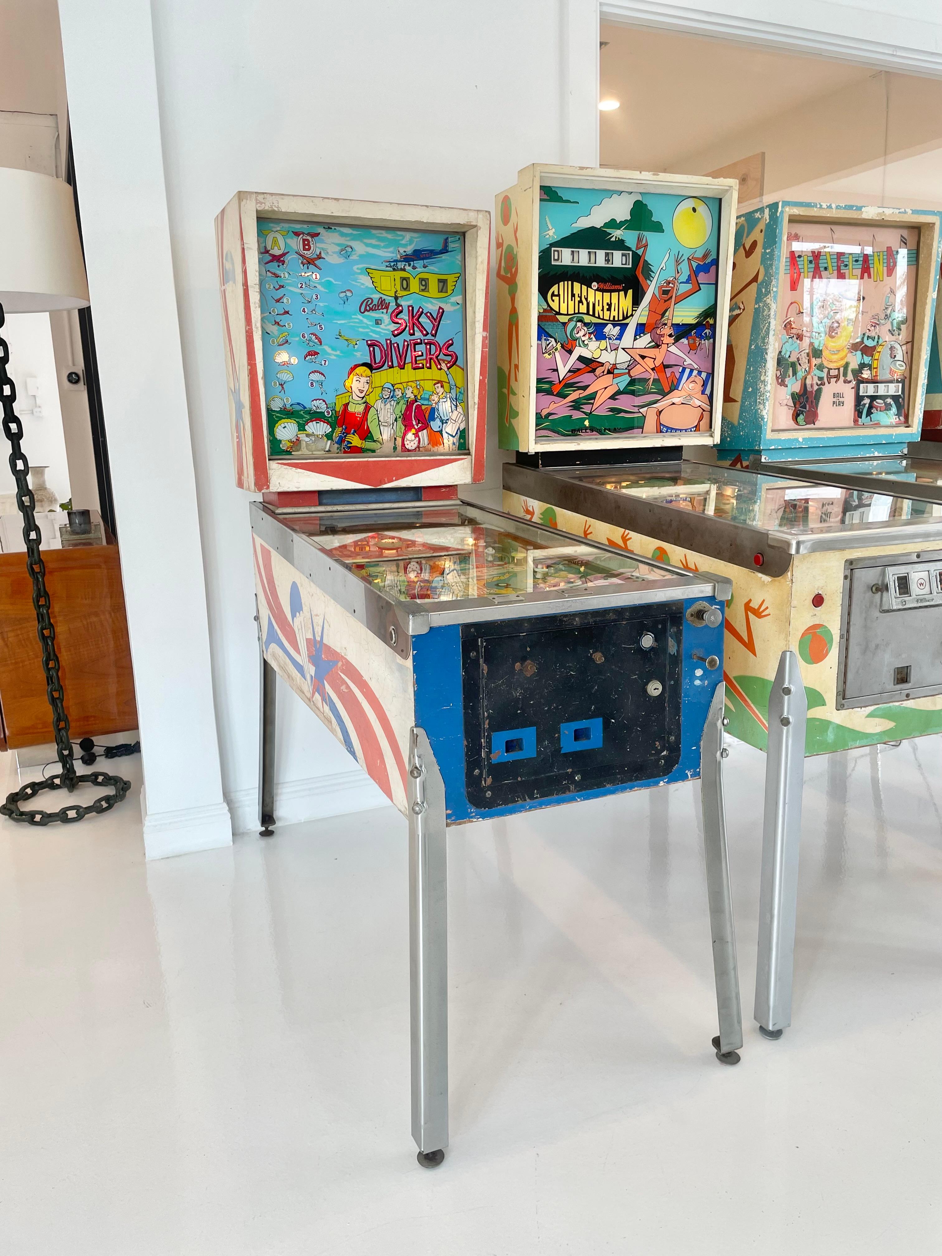Vintage 'Sky Divers' pinball machine from 1964. Designed by Ted Zale and manufactured by Bally Manufacturing Co. Only 2,250 produced. In excellent working condition. Great visuals and sounds. Extremely fun paced gameplay. 

This game features