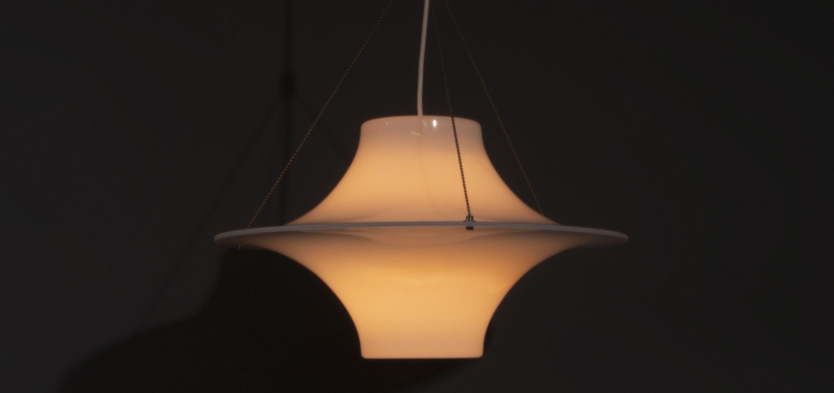 Sky Flyer pendant lamp designed by Yki Nummi in Finland in the late 1950s. Yki Nummi was the first Finnish designer to use Plexiglas as a material for a pendant lamp. By using plexiglass, the light is beautifully filtered. The Sky Flyer pendant lamp