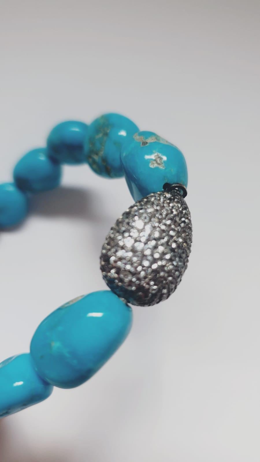 Nice bracelet made up of  sky topaz pave on silver setting, natural turquoise beads and macrame clasp. 
Sky Topaz pave ct. 3,75
Natural turquoise beads
macrame clasp system
Total diameter cm 7 - it fits well for a medium wrist ( about 15-16 cm) 