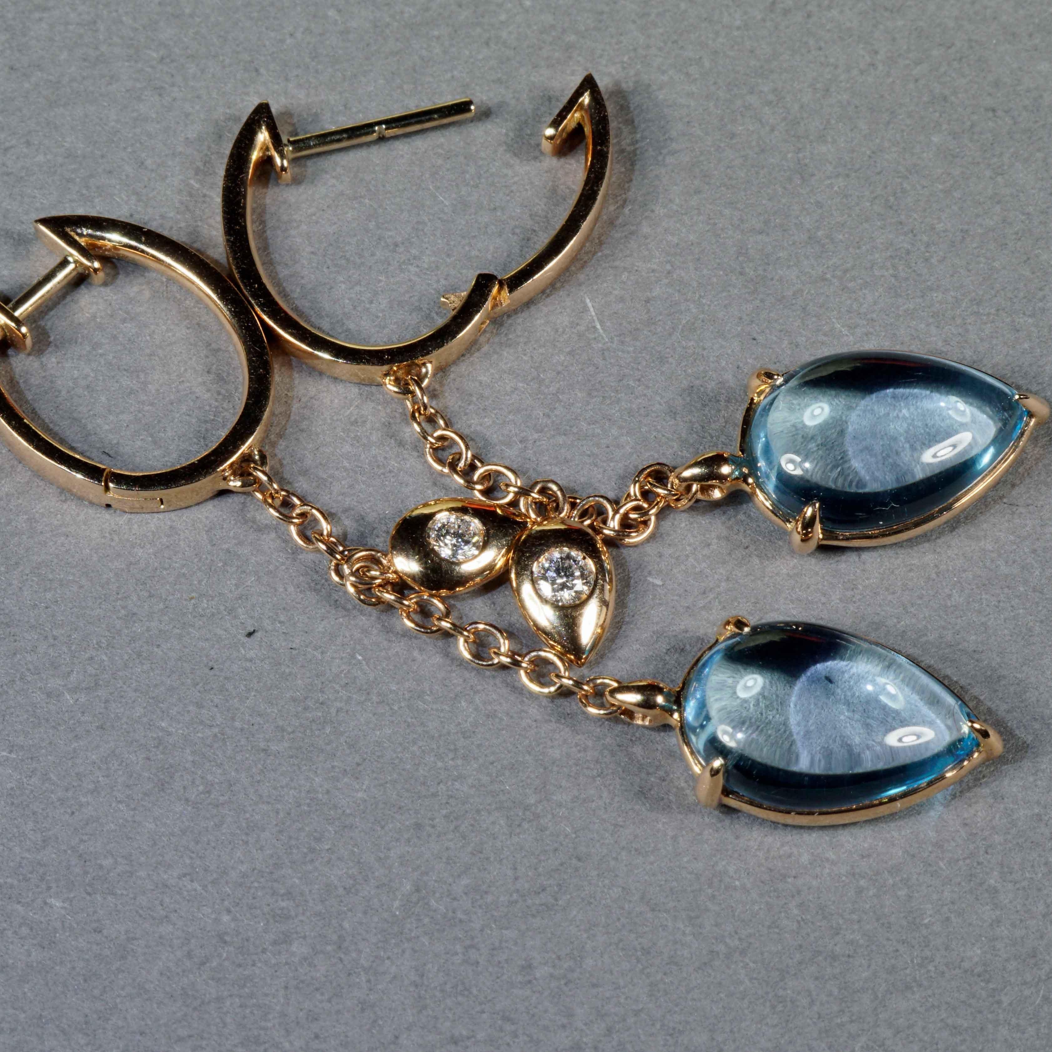 Earrings made in our traditional Italian goldsmiths in Valenza, modern chain design, earrings each with a skyblue light blue topaz cabochon measuring 13 x 9 mm in the shape of a teardrop, totaling approx. 8.88 ct, fixed as a long pendant with a