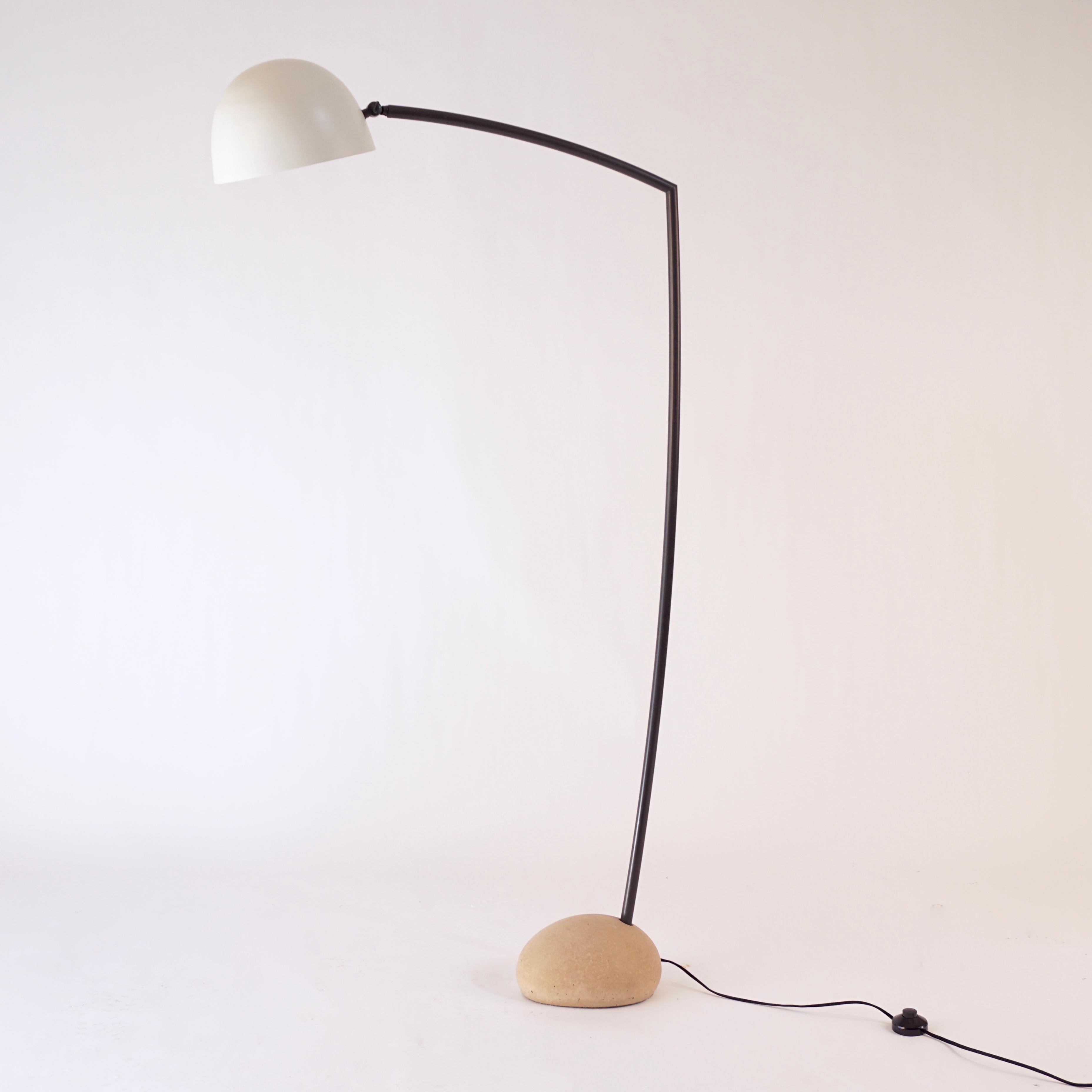 This is the large version of the sky floor lamp. The light colored cement base was made with forms taken from actual stones from the Isle of Skye. The arm is solid bronze with an acid darkened patina, the shade is a hand spun aluminum shade that has