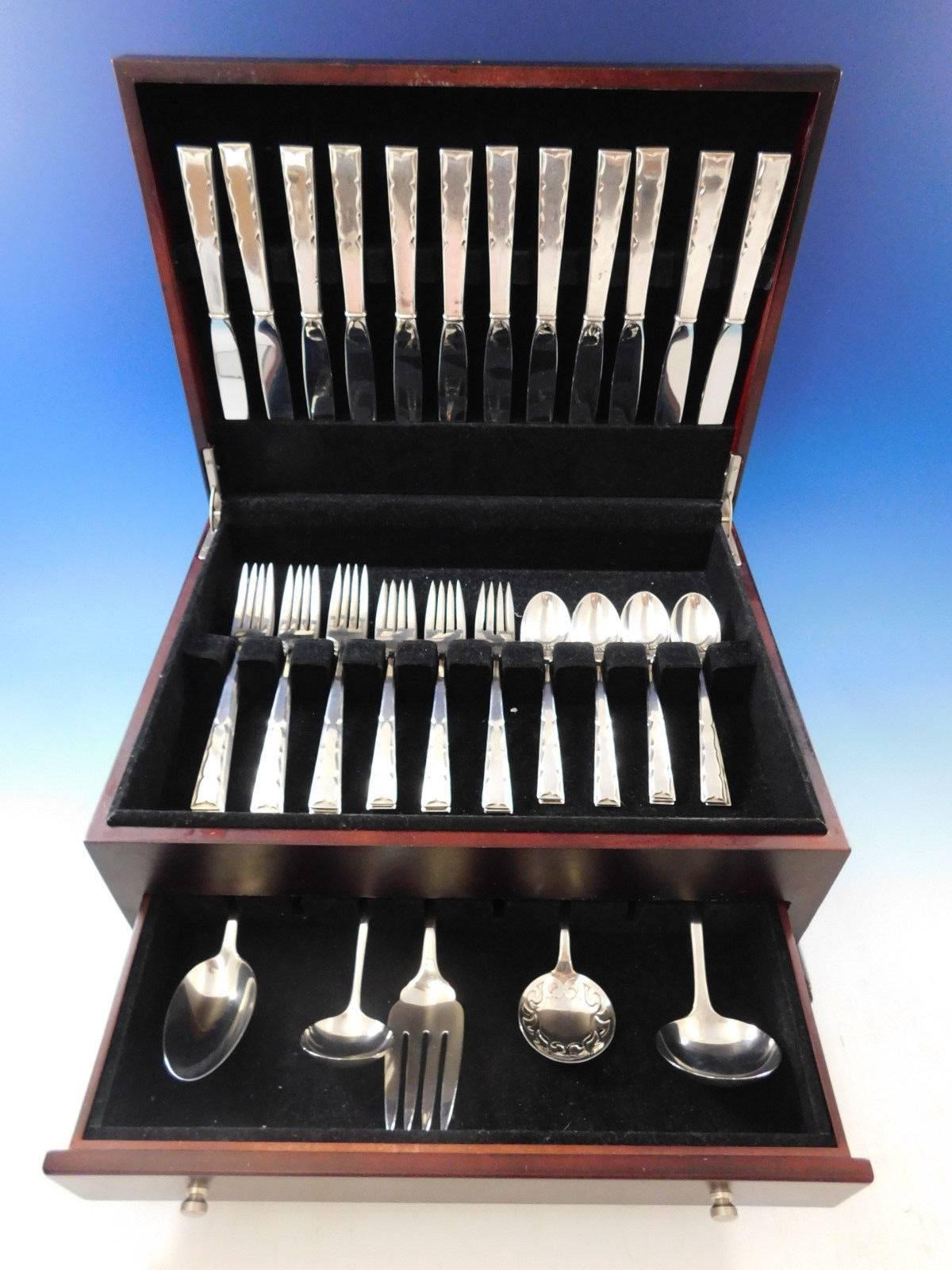 Skylark by Kirk Stieff, circa 1954 sterling silver flatware set, 53 pieces. This set has a very unique look and includes:

12 knives, 9