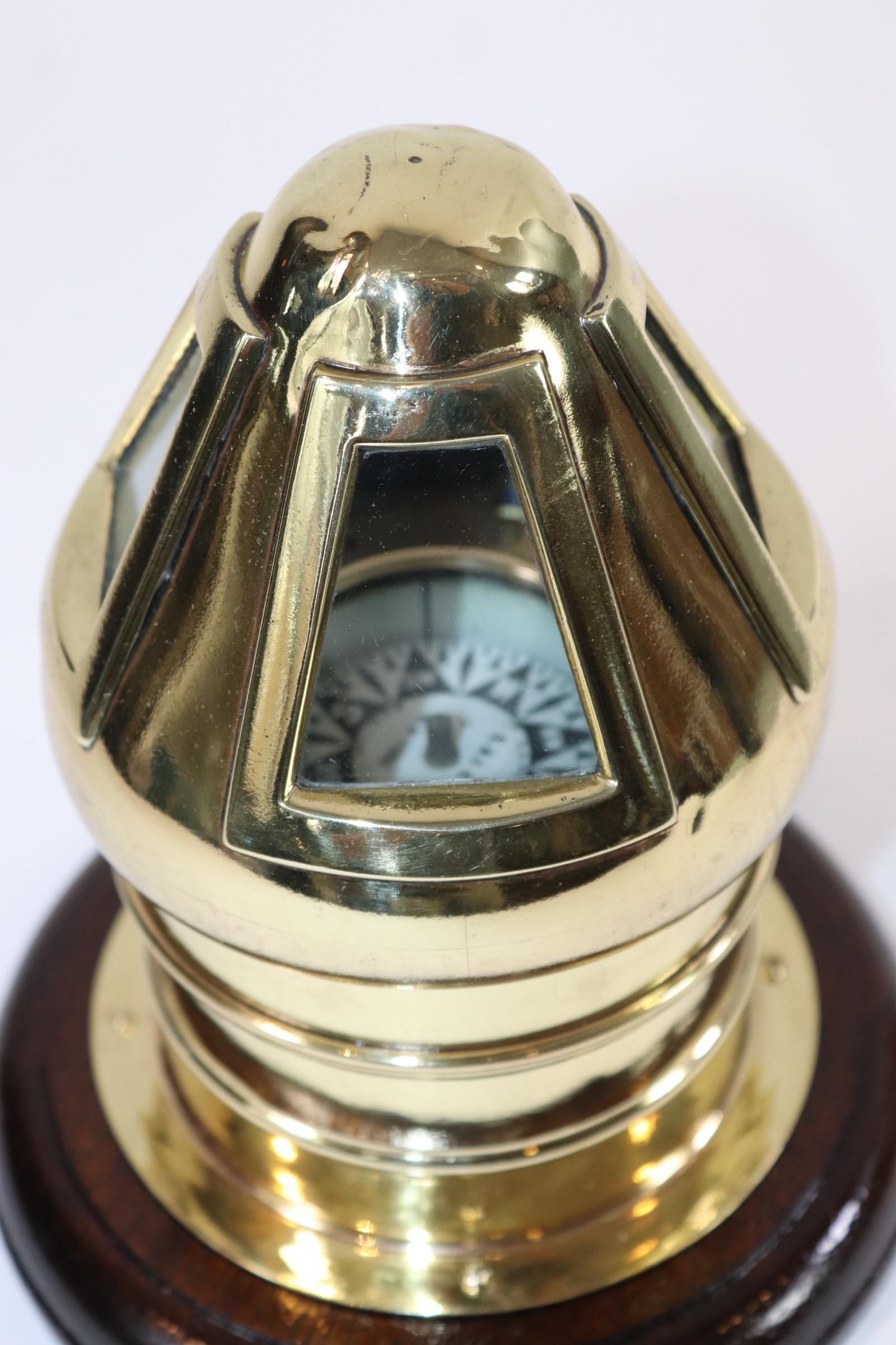Solid brass yacht binnacle with gimbaled compass from E.S.Ritchie of Boston. Compass dates to the 19th century. The skylight top is fitted with four glass panes. Mounted to a varnished wood base. Weight is 4 pounds.