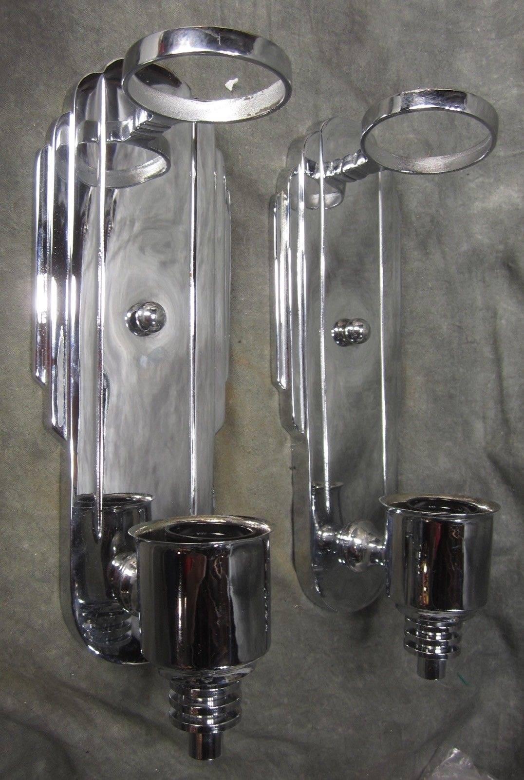 Streamline stunning pair of skyscraper art deco sconces from 1930s. A high quality original design in polished chrome Beautiful stepped backplates with original faceted cylindrical white milk glass. Amazing design with attention to all details.