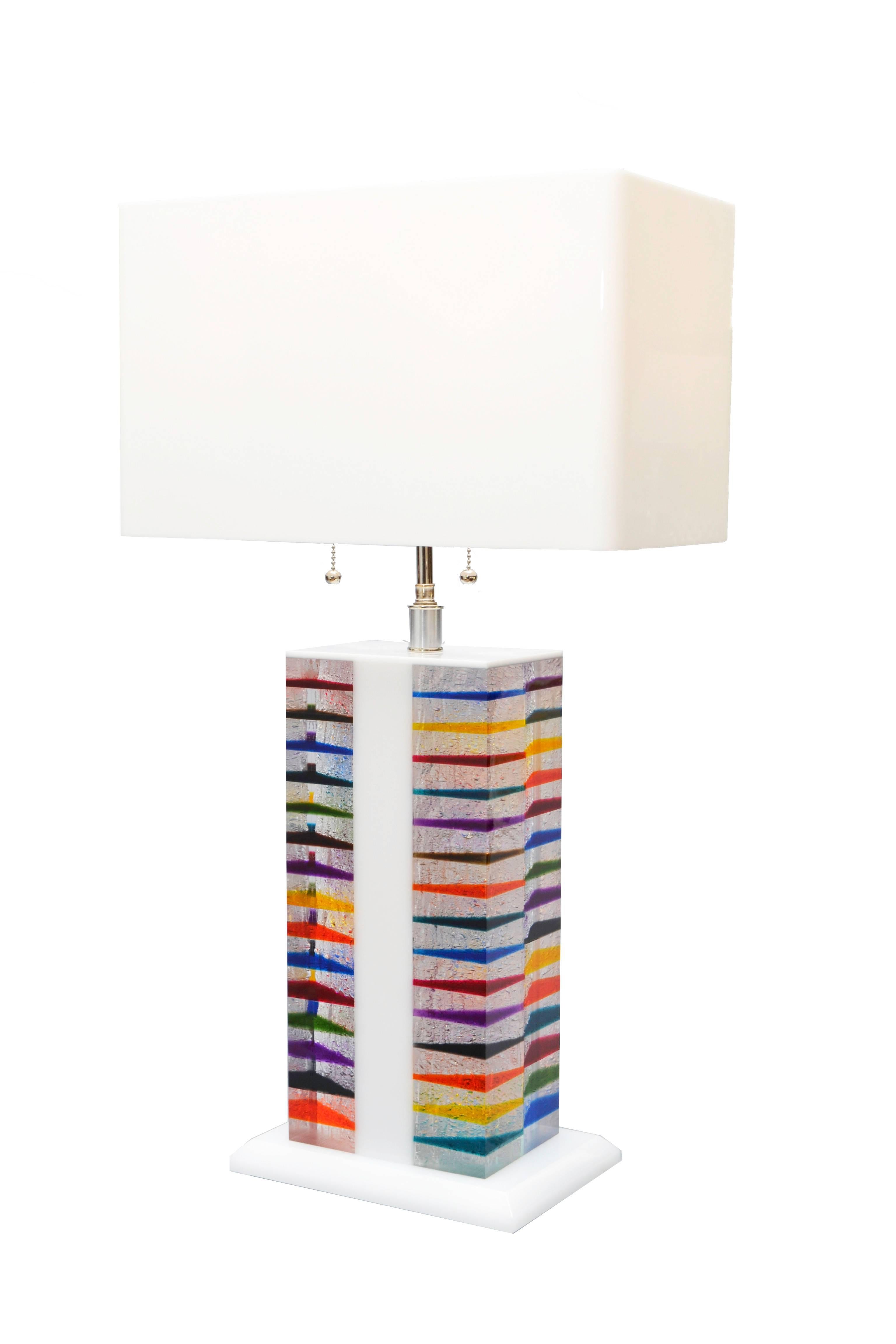 Pop Art Architectural shaped table lamp in bright Rainbow colors. Comes with a unique matching rectangular shade in white Acrylic.
The Nickel lamp holder can support two light bulbs of max 60 W each and is of the highest quality.
This lamp is our