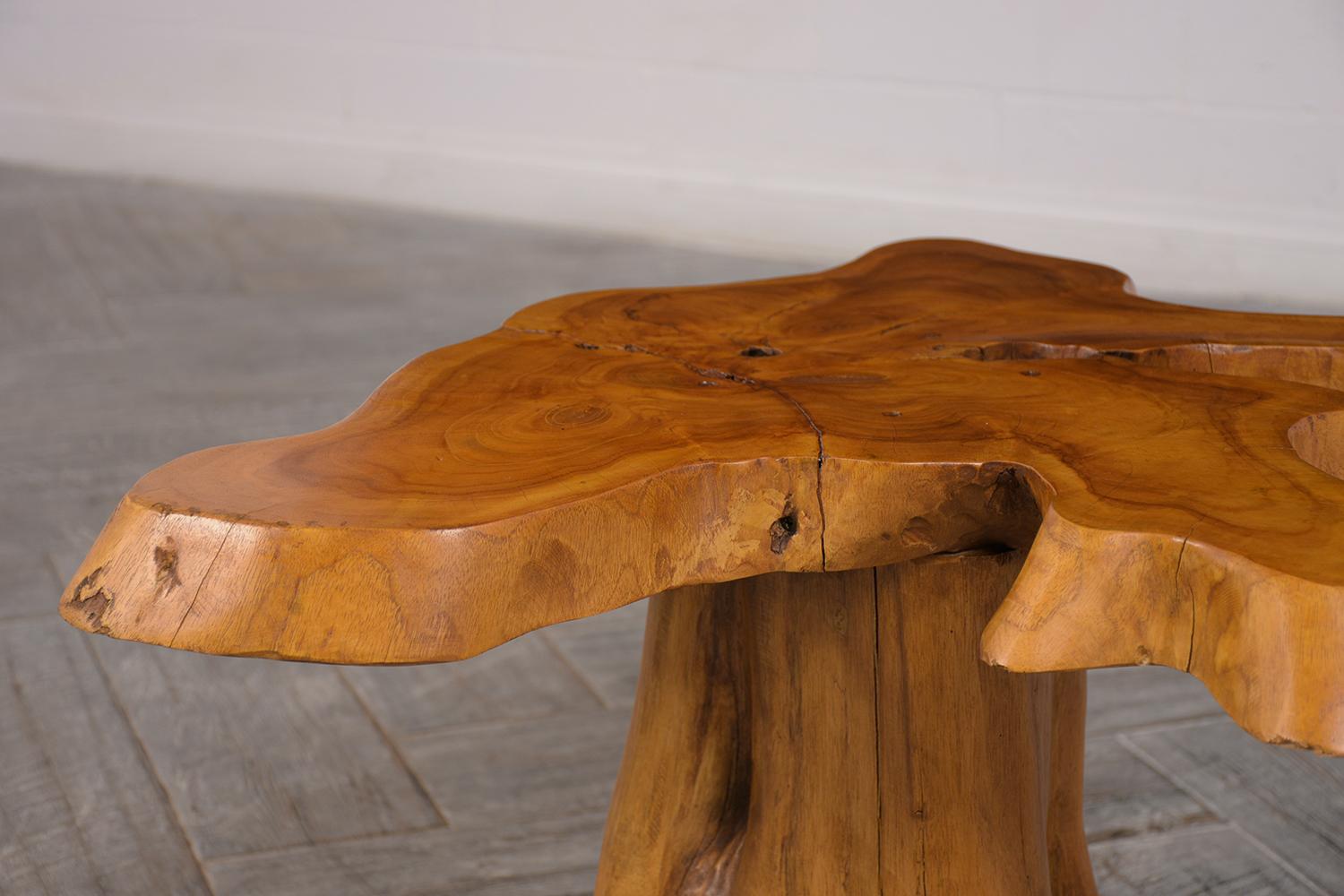 Vintage tree root side table. Has a 2-inch thick wood slab top, with freeform design root pedestal legs. Its stain in its natural color finish, with a French wax and has been polished to give a smoother finish. Can also be used as a stool, or bench.