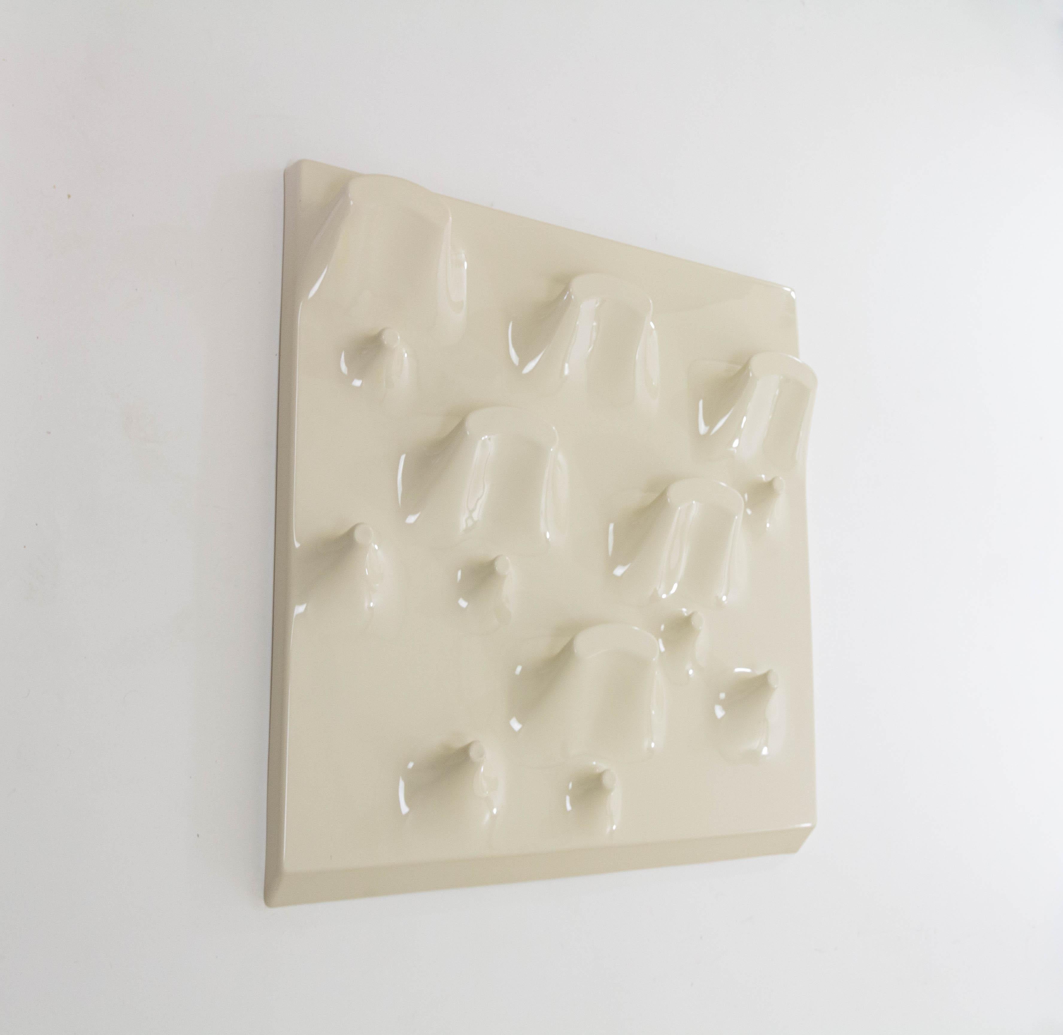 Slab coat rack, which doubles as a sculptural wall object, designed by Jonathan De Pas, Donato D’Urbino and Paolo Lomazzi for Longato Arredamenti in Italy in 1969.

This object, designed as a coat rack, is made of plastic and has fourteen hooks in