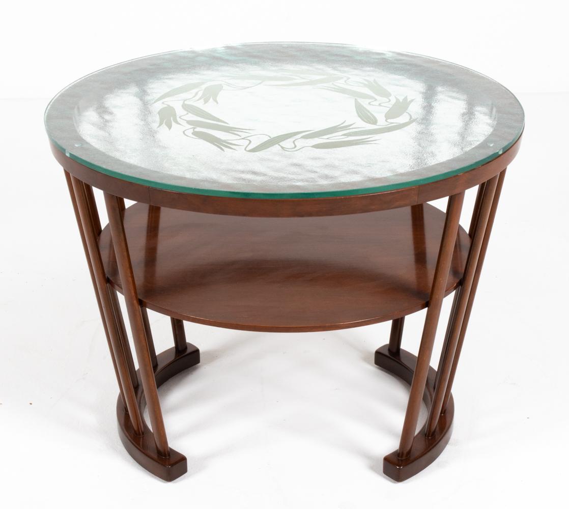 This stunning Danish mid-century two-tier end table is a finely crafted piece by leading Scandinavian manufacturer Slagelse, c. 1940's-50's. From the earlier decades of the Danish modern period, this table is imbued with vestiges of Art Deco design.