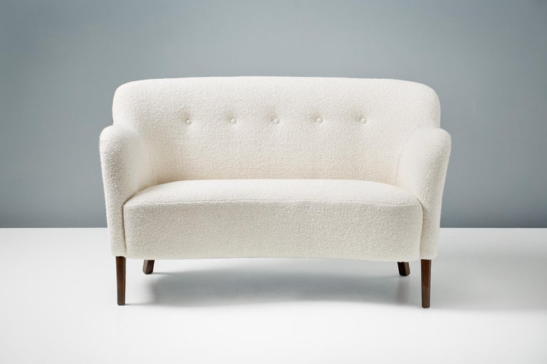 This exceptional piece of Danish furniture was designed and made in the 1950s by master cabinetmakers Slagelse Mobelvaerk in Denmark. 

This example has been reupholstered in luxurious wool boucle fabric from Dedar Milan at our workshops in