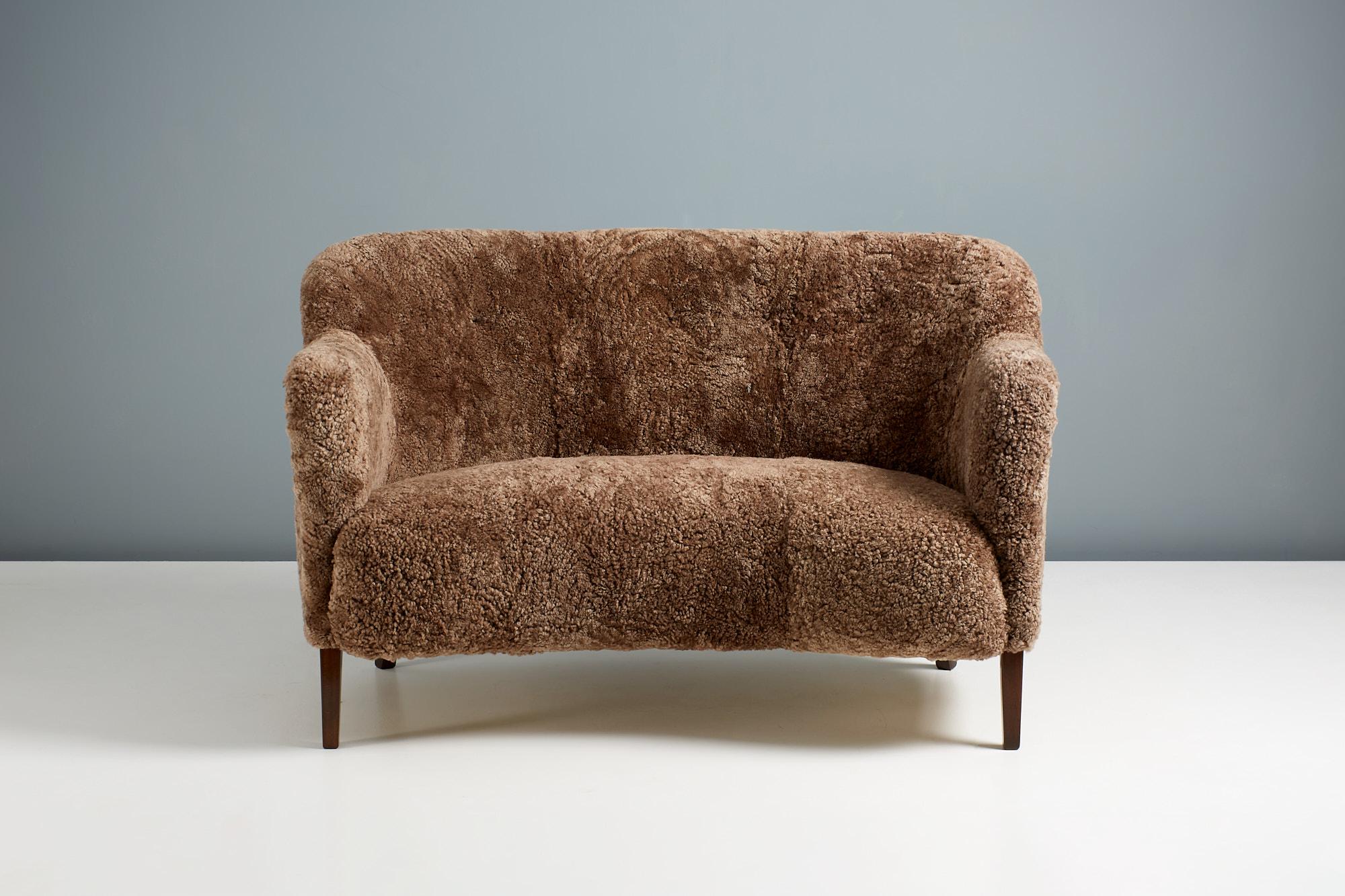 This exceptional piece of Danish furniture was designed and made in the 1950s by master cabinetmakers Slagelse Mobelvaerk in Denmark. 

This example has been reupholstered in luxurious Austrlian Sahara brown sheepskin Skandilock, Sweden at our