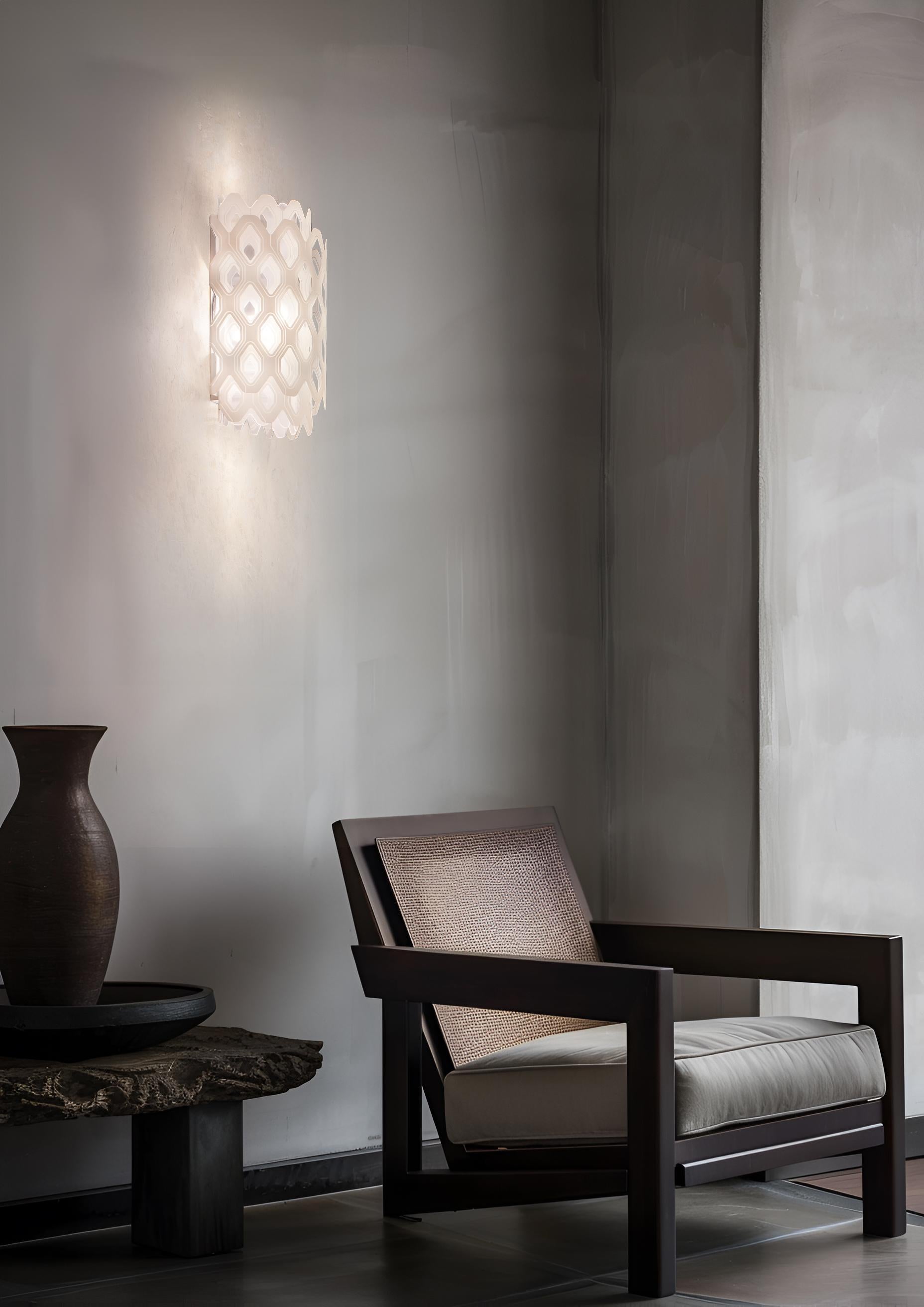 Charlotte was created from a world of illusion, from the challenge of turning a two-dimensional element infinitely multiplying shapes. The light resembles that of waves pulling away from the shore, leaving little illuminated drops behind.