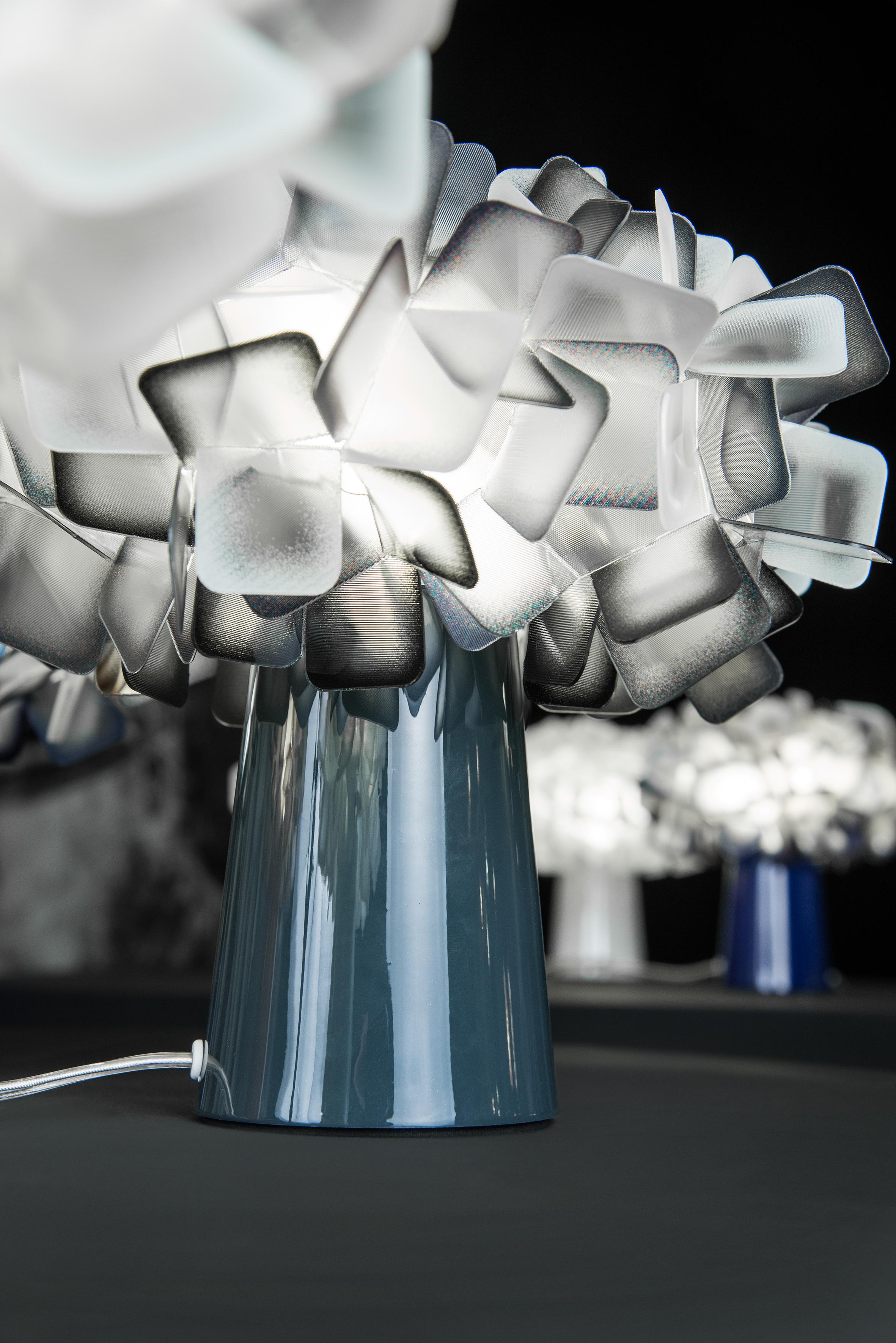 Clizia is a series of shapes fit together to create a perfect balance of reflections and transparencies. The lamp has taken note of natural forms, resembling a cloud that captures the first changing rays of morning sun, or a treetop filtering a play