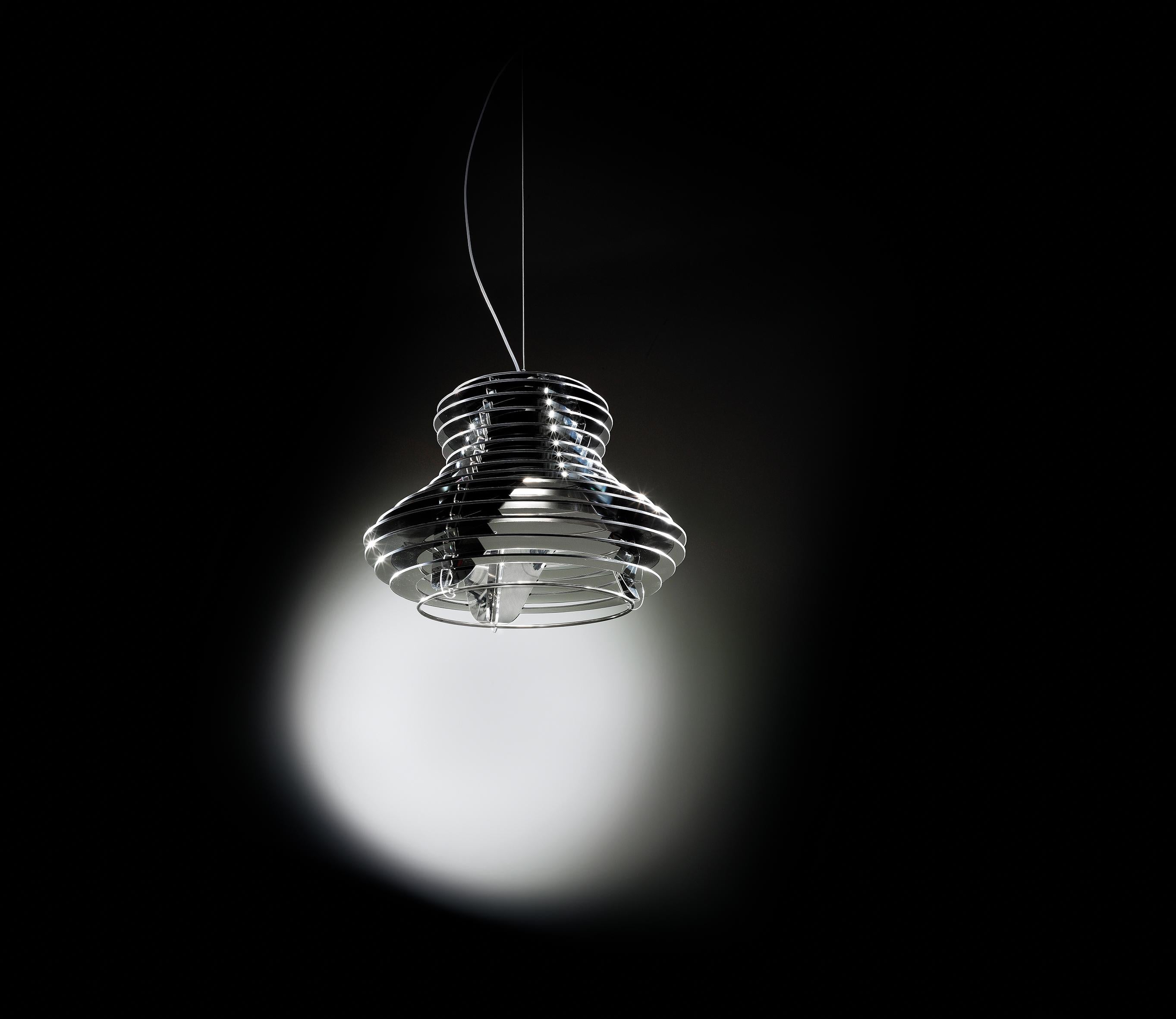 A modern shape, rigorous geometry, rigid and penetrating lines that soften around a central cone surrounded by layered rings that play with the light without losing form. The lamp’s curves were inspired by the evocative rolling hills of the Tuscan