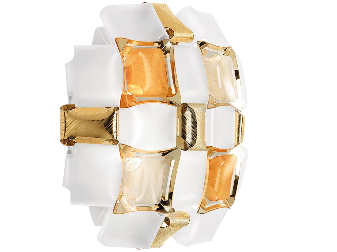 Mida is inspired by the world of haute couture jewels. A pavè of precious gems encrusts an almost invisible setting, and polished cabochon are geometrically scattered across a floral corolla with silky, iridescent tones. The designer used colored