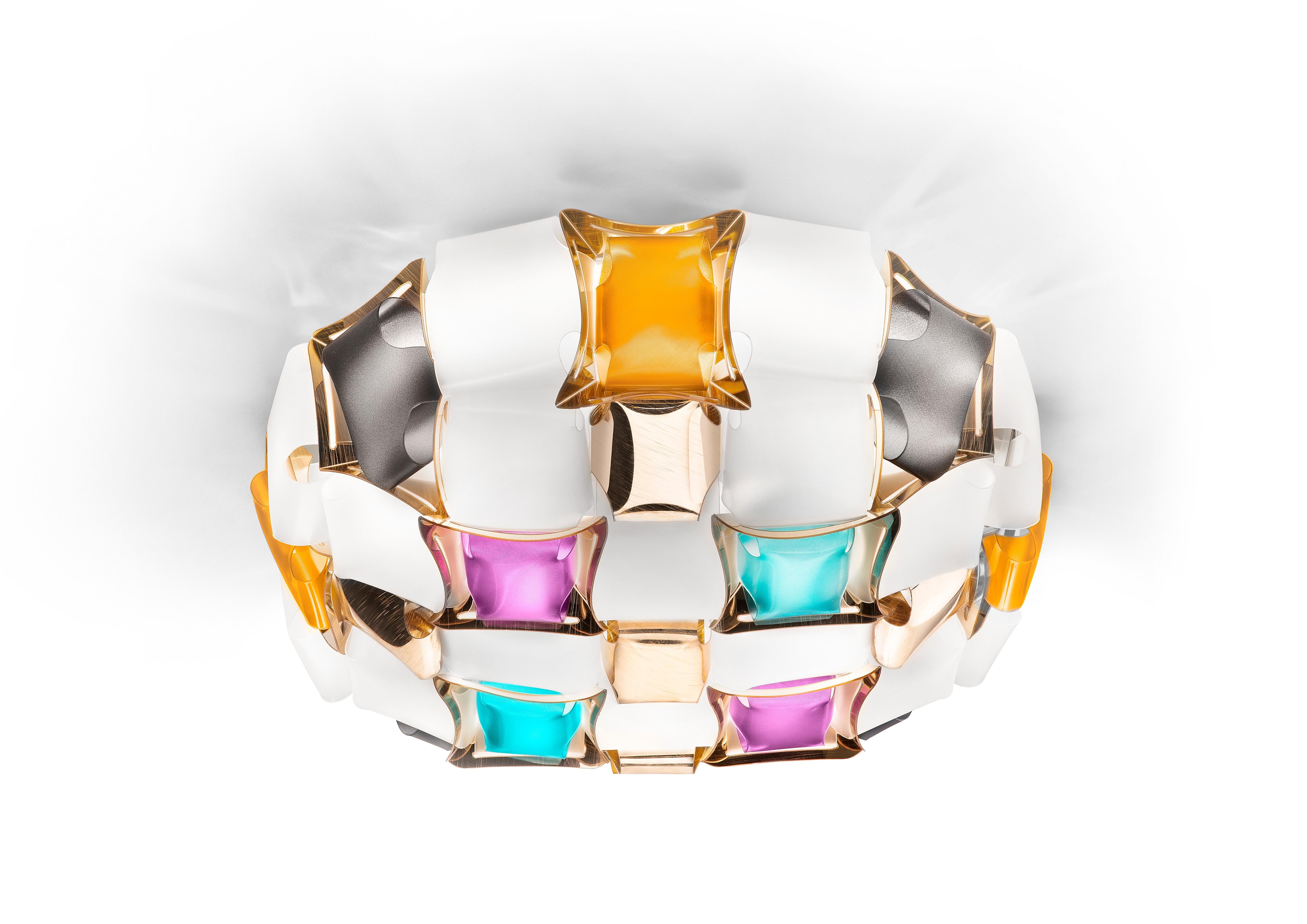 Mida is a ceiling/wall lamp with our exclusive magnetic system, inspired by the world of haute couture jewels. A pavè of precious gems encrust an almost invisible setting, and polished
cabochon are geometrically scattered across a floral corolla