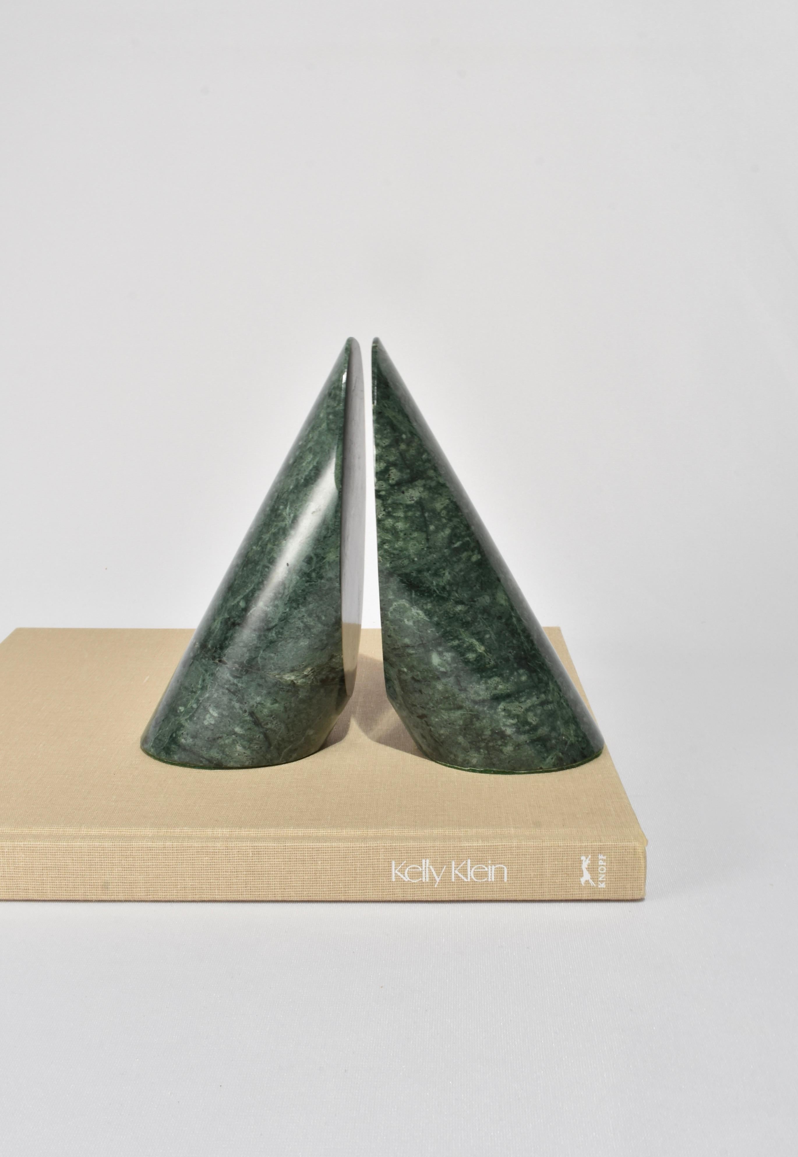 Slanted green cylindrical granite bookends on a green felt base, set of two.