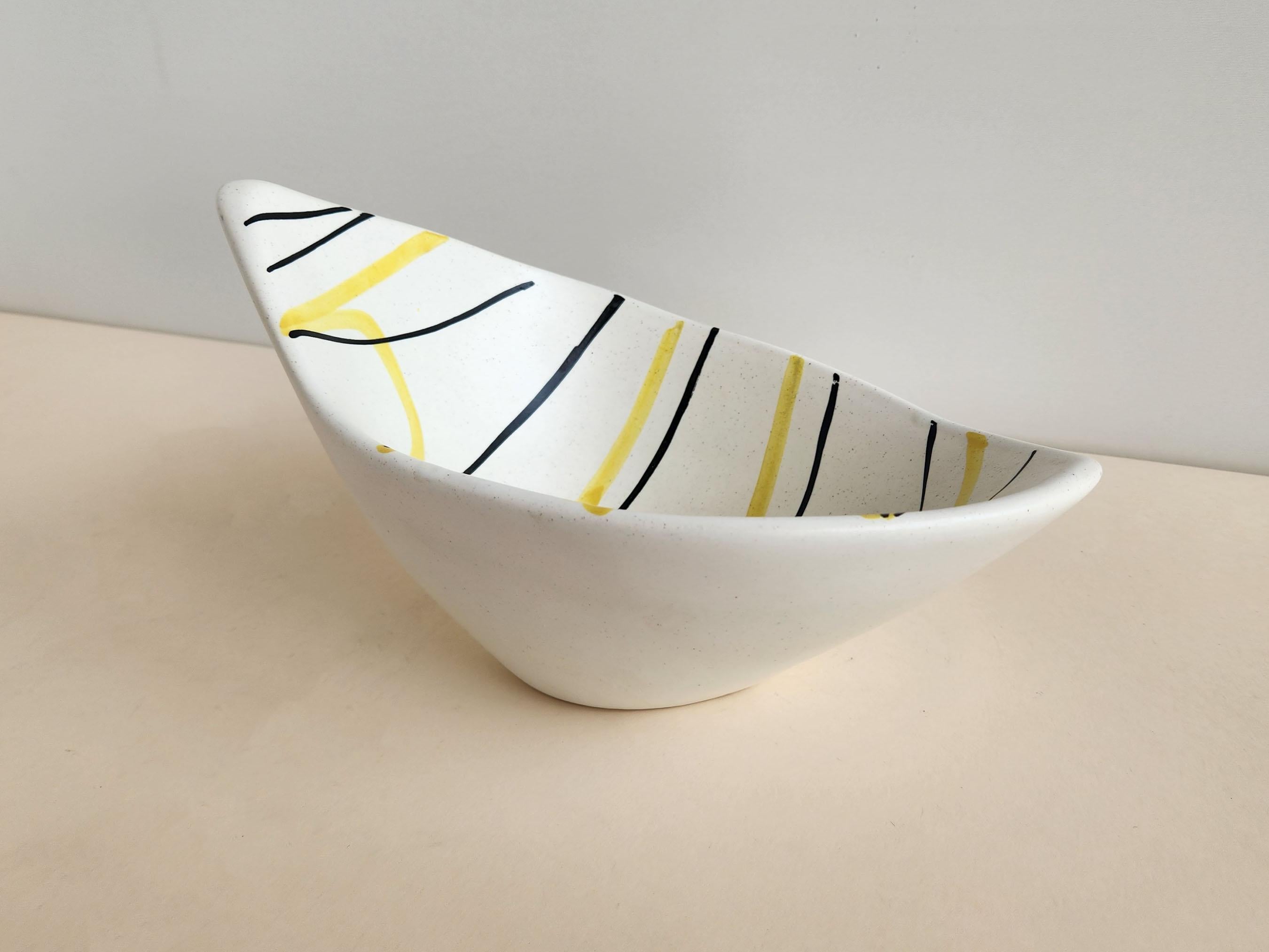 Slanted Vintage Ceramic Bowl with Yellow and Black Lines by Roger Capron - Vallauris, France

Roger Capron was in influential French ceramicist, known for his tiled tables and his use of recurring motifs such as stylized branches and geometrical