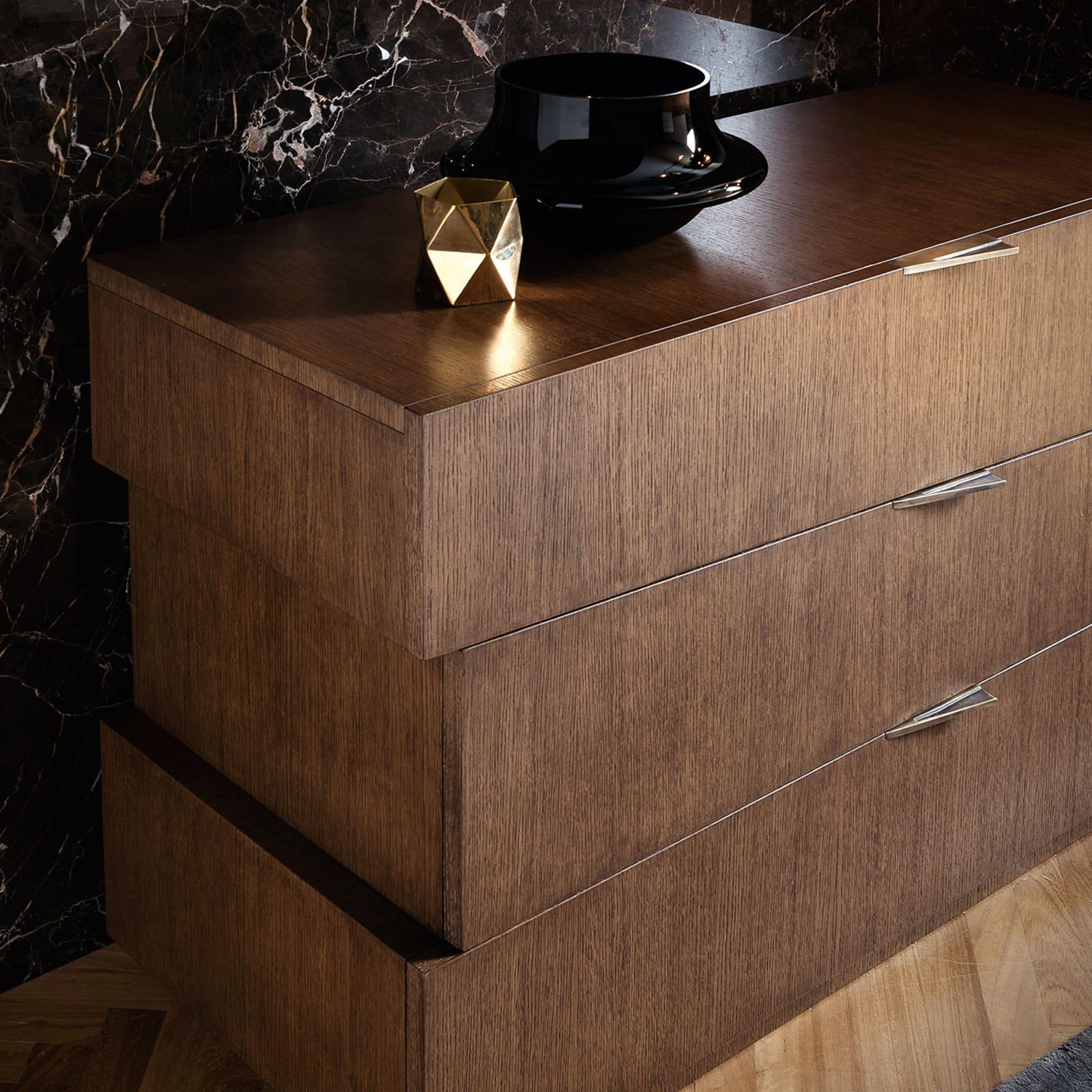 This sideboard is a one-of-a-kind piece of contemporary allure boasting an interplay of irregular shapes to reveal a striking, sculptural effect. The sideboard is composed of three soft-closing drawers of durmast wood enriched with metal handles