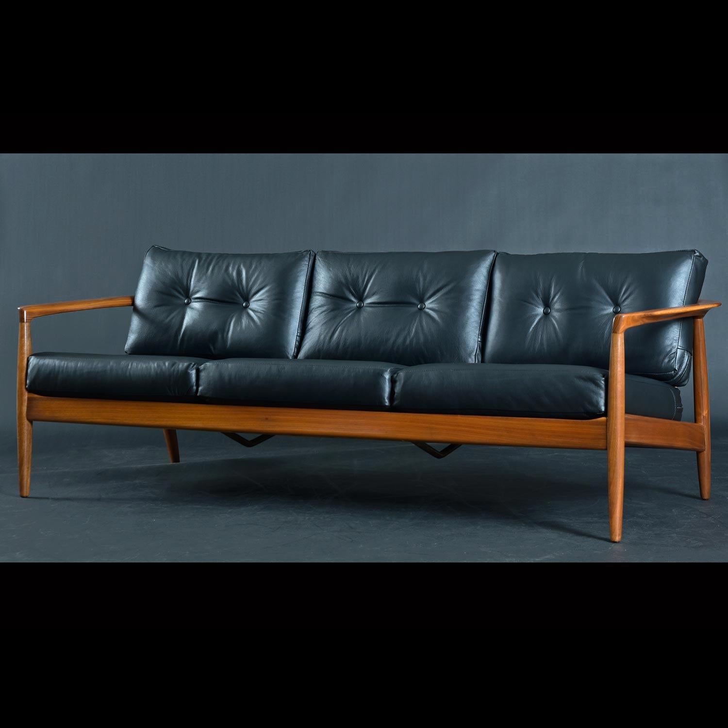 This stunning Swedish made sofa by Dux is one of the finest walnut wood frame sofa’s we have seen from the period. Vintage 19560s, the designer, Folke Ohlsson expands on the quintessential wood frame sofa to create something truly special. Also