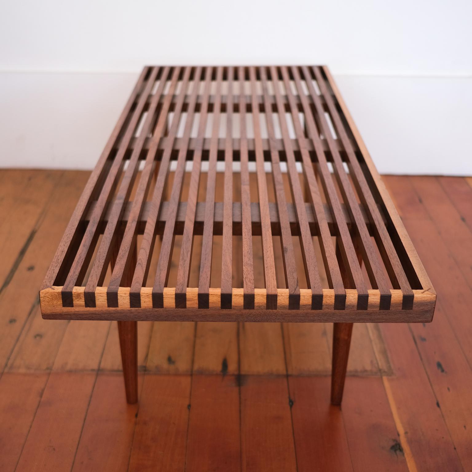 Slatted coffee table or bench with tapered legs by Mel Smilow. Beautiful walnut grain and joinery. USA, 1950s.