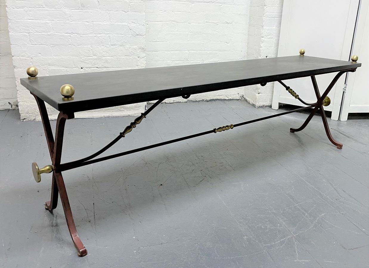 Slate and brass coffee table. The table has a painted iron frame with brass accents.