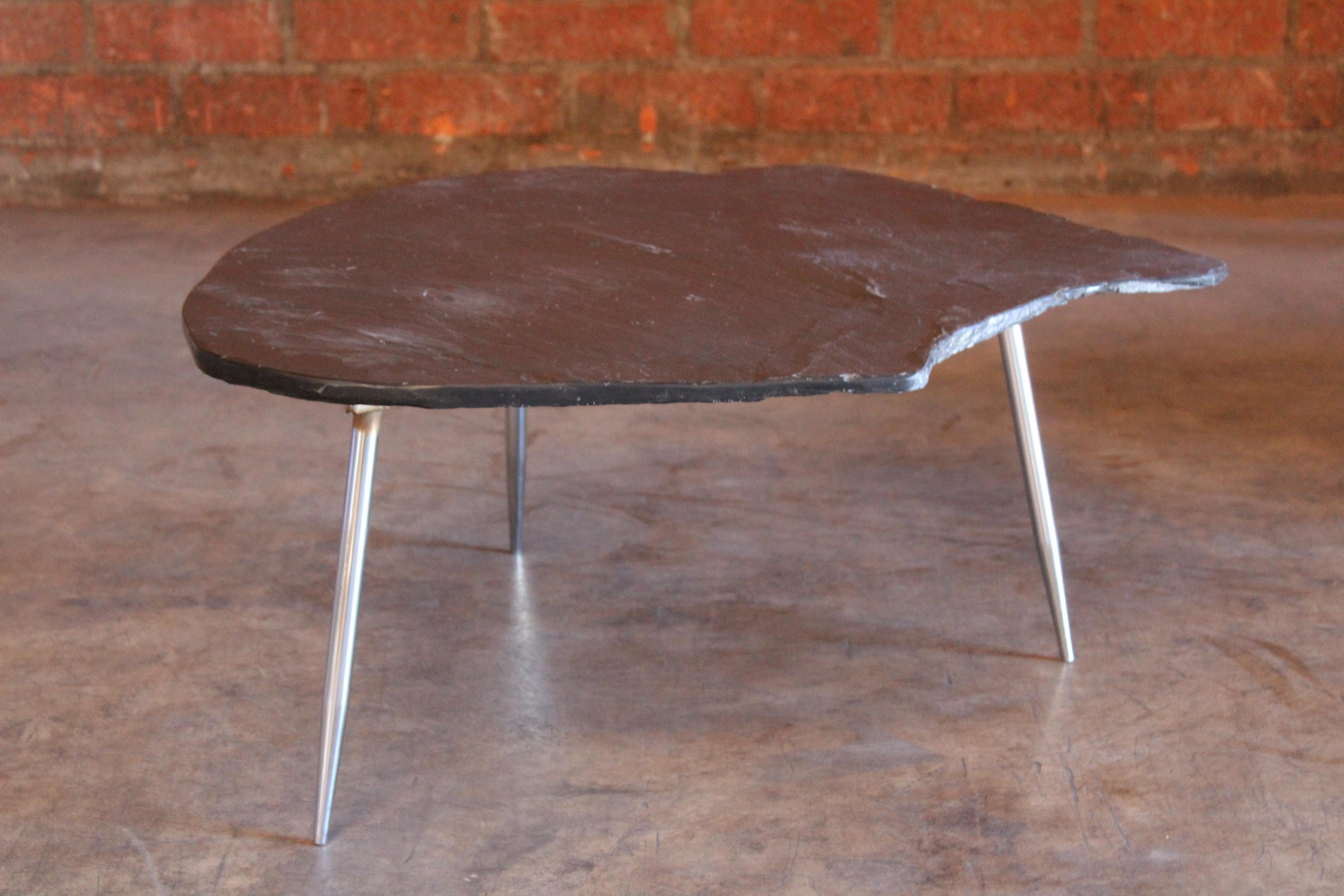 A vintage natural slate stone topped coffee or side table on a chromed steel base with stiletto legs, France, 1960s. In overall wonderful condition. The slate top has one chip on the edge. The chrome base has minor oxidation which is mostly on the