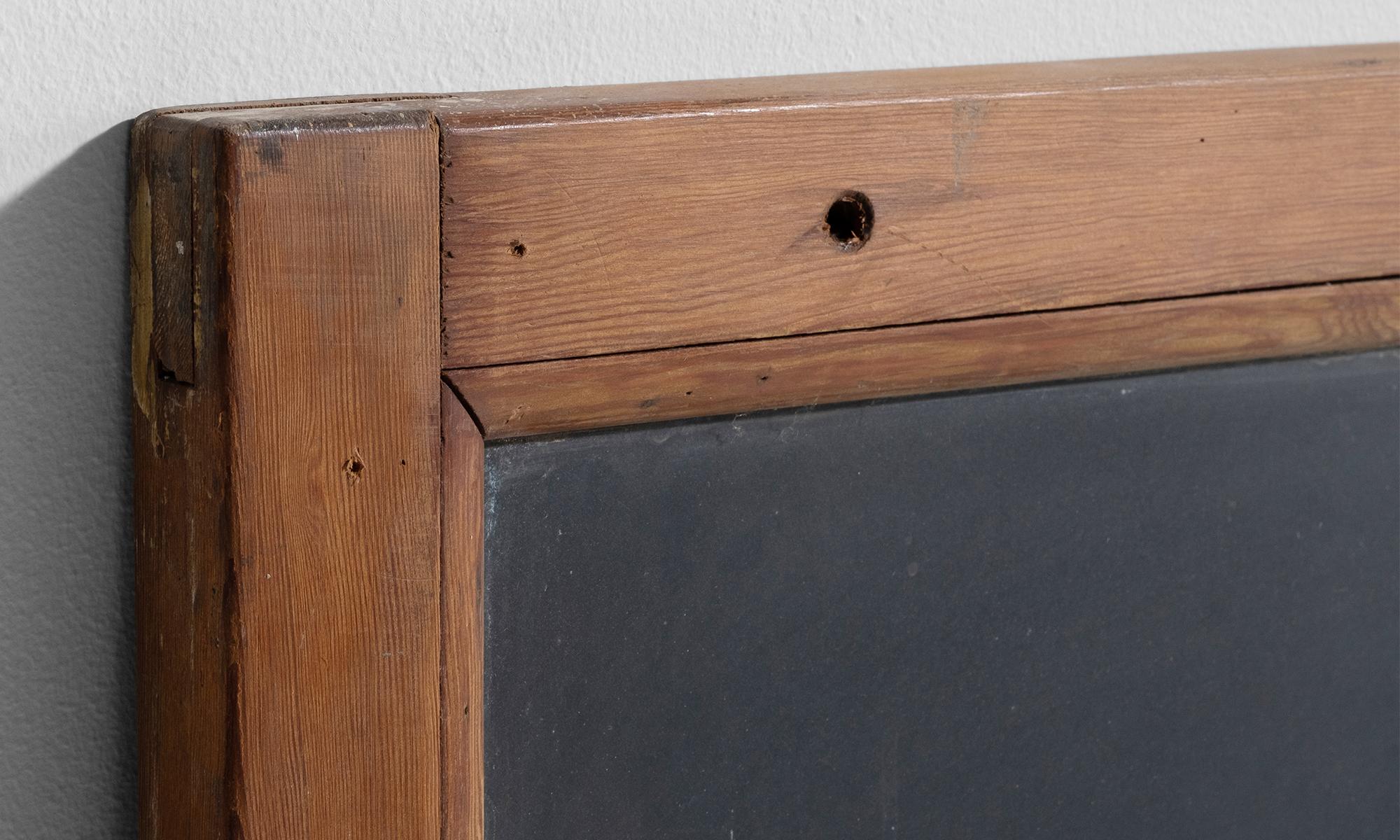 Solid slate in original wooden frame.