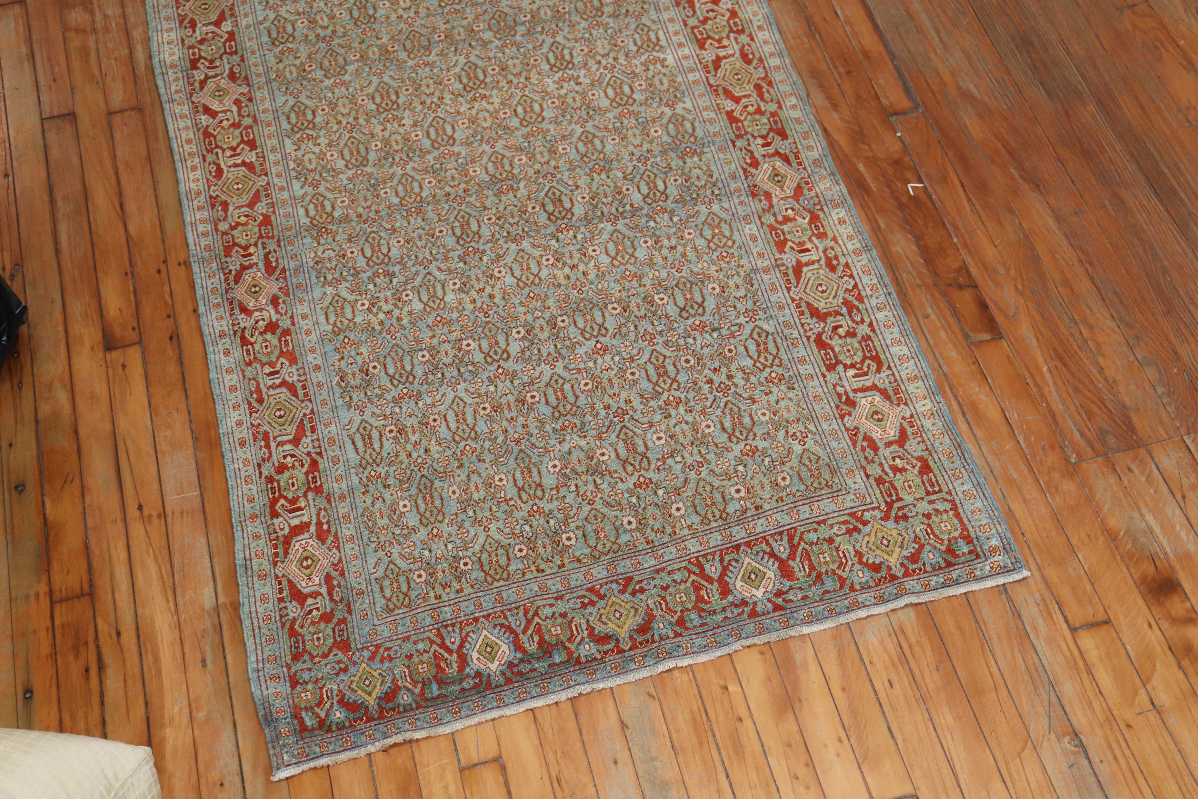 Fine quality slate blue field, red border Persian Senneh Runner. It has that repetitive Classic Herati design you see in most senneh rugs. The colors are dreamy, circa 1910.

Size: 3'7