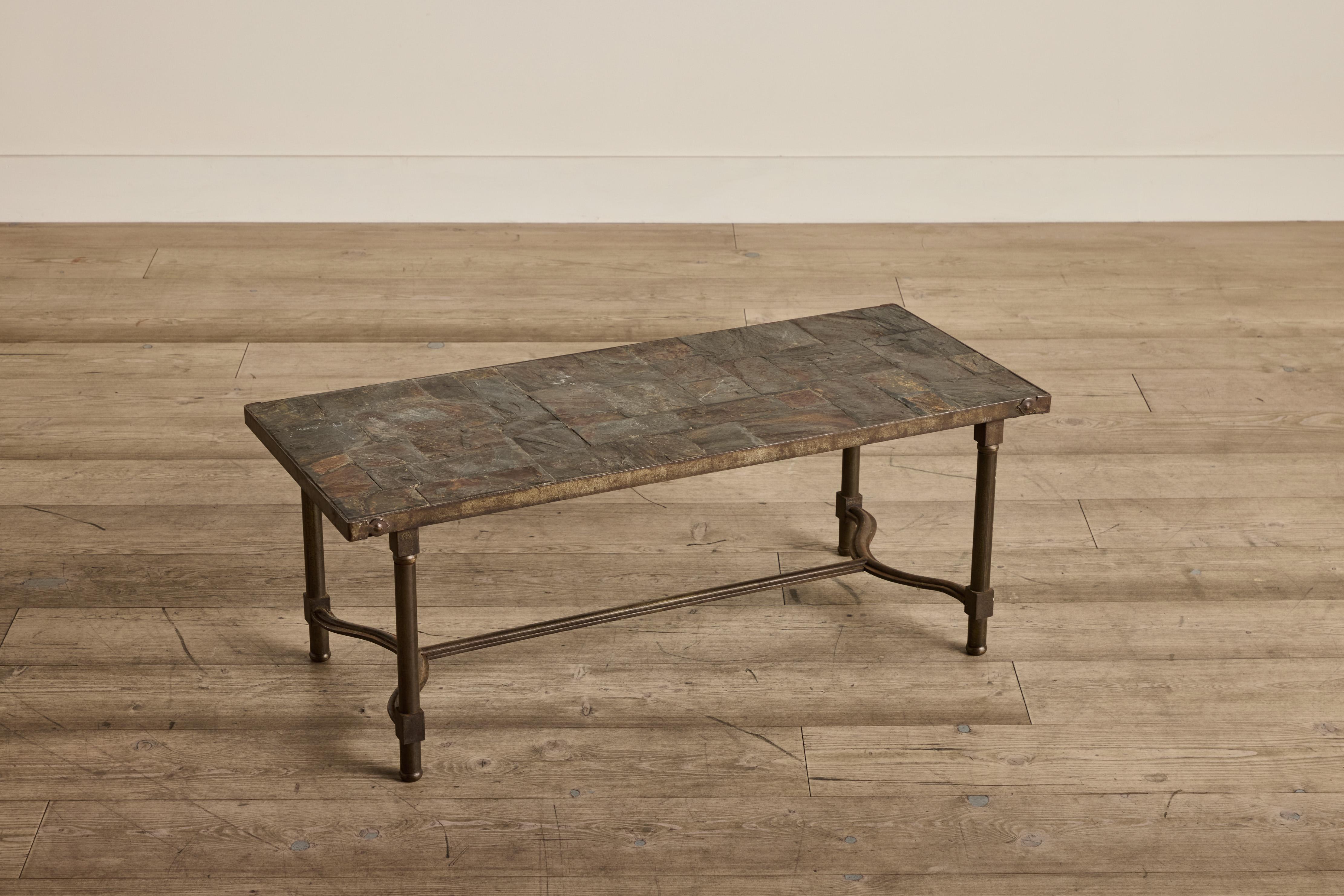 Slate top coffee table with an iron base from France circa 1960. Wear on stone and iron base is consistent with age and use. 

