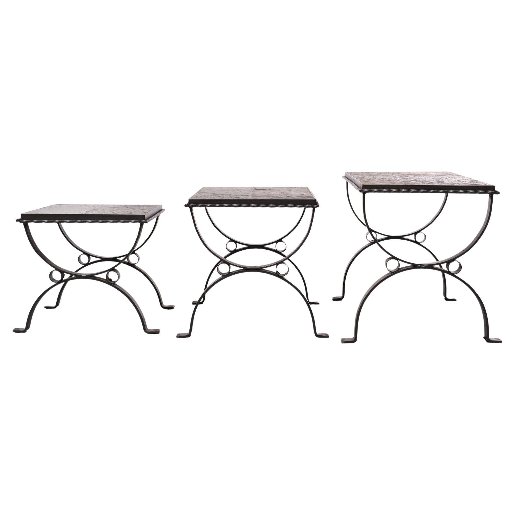 Very nice Brutalist set of Three nesting tables. Wrought iron comes with a Slate stone 
top. Very good condition. 1970s.