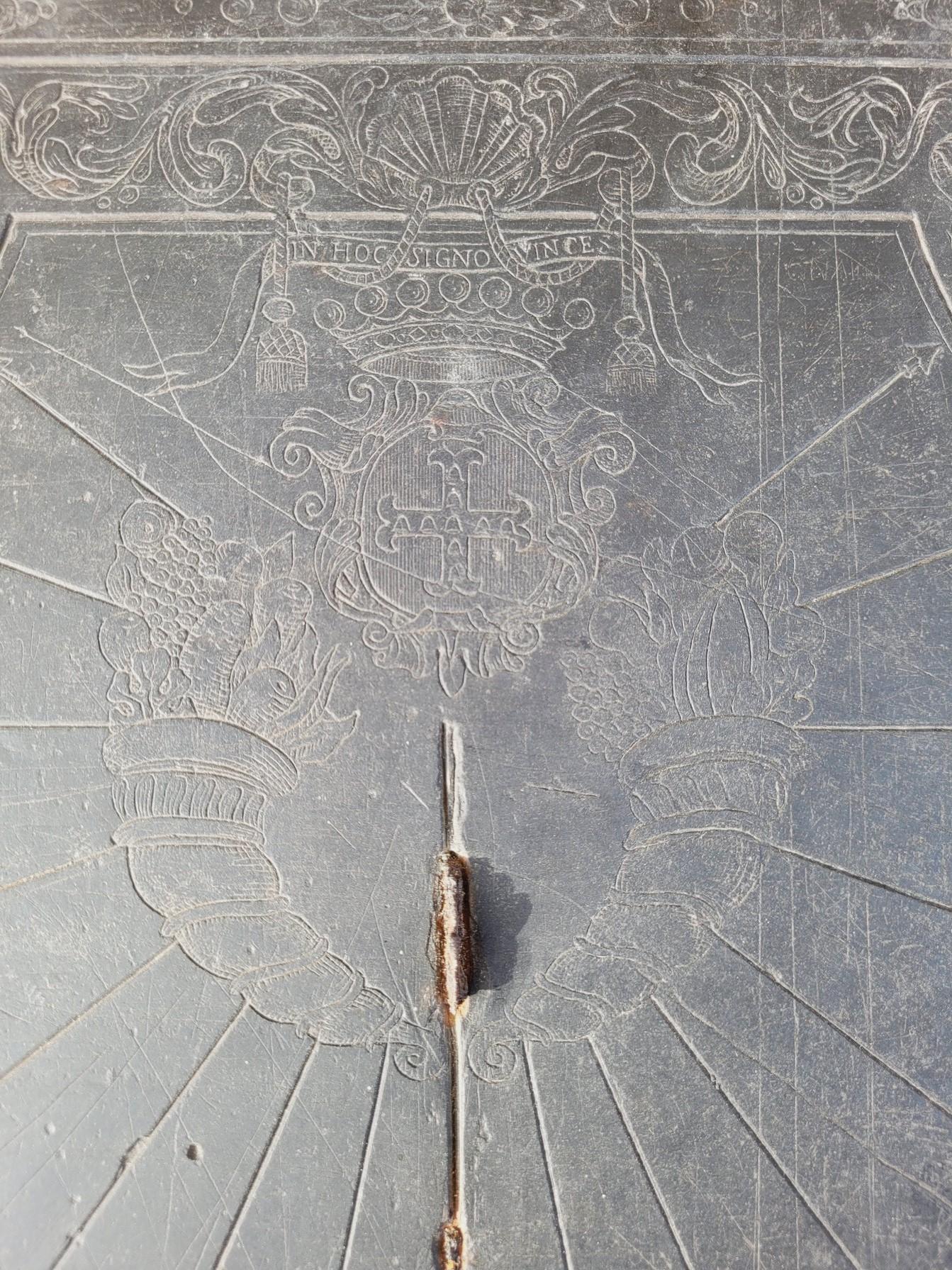 Slate sundial engraved and decorated with cornucopias, shells and a crown topped with the motto 
