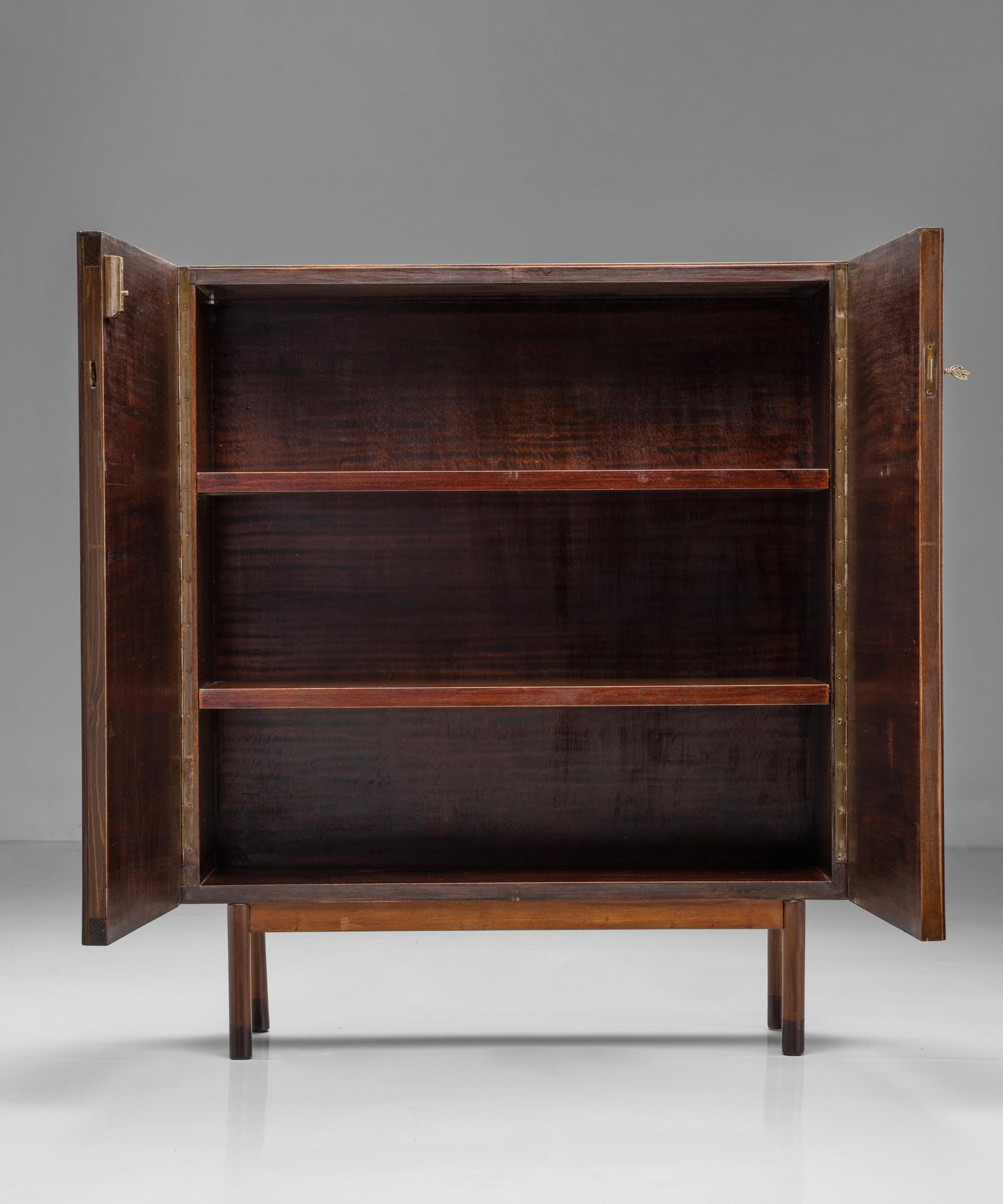Slatted mahogany buffet

Italy Circa 1950

Finely crafted cabinet in mahogany, with two interior shelves and original brass hardware.

Measures: 38.5” W x 12.5” D x 45” H.