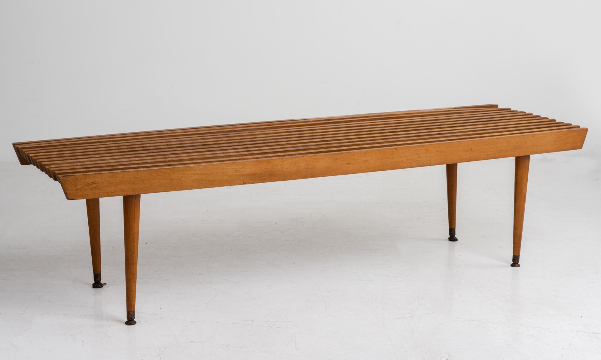 Slatted modern coffee table

America, circa 1960

Hardwood coffee table with brass feet.

Measures: 60