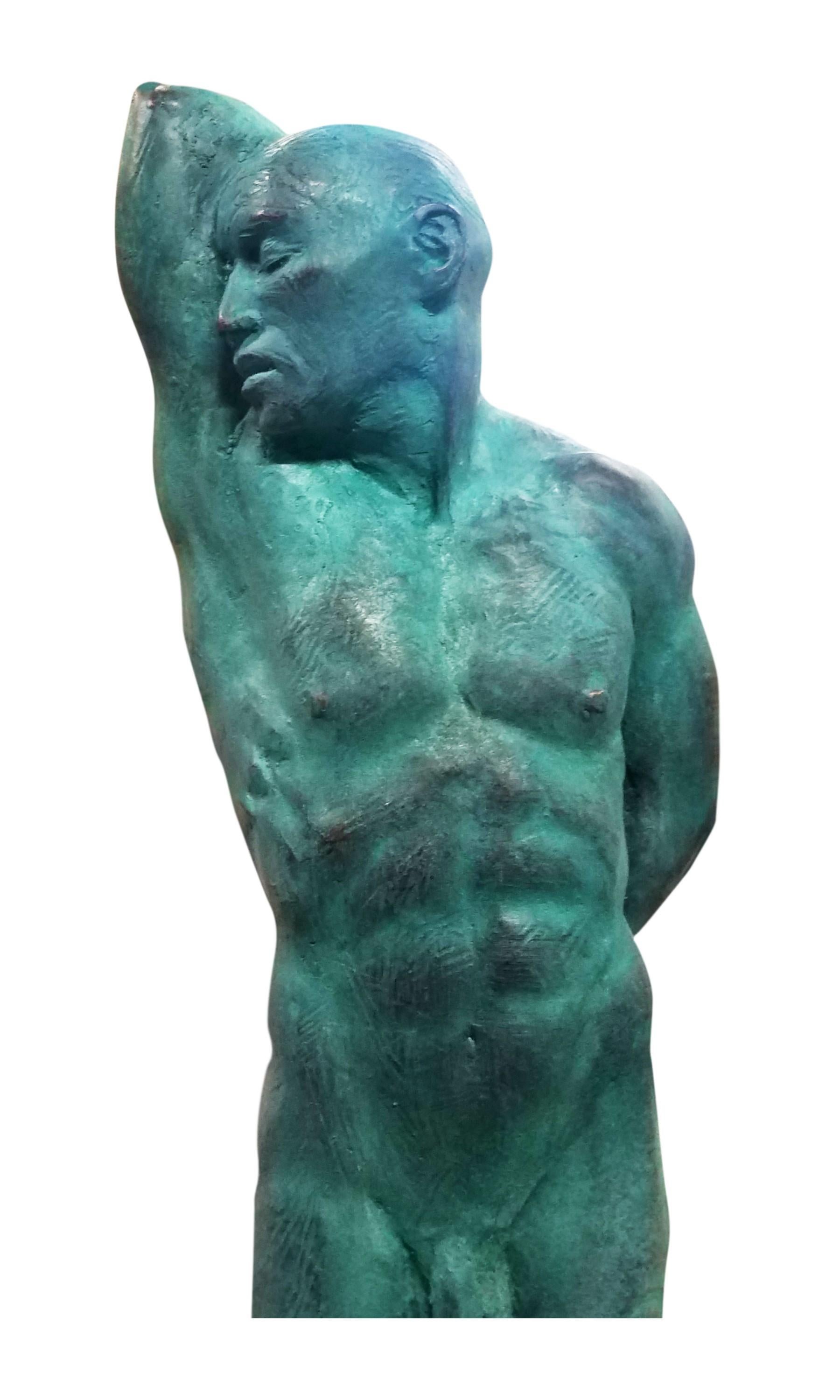 This is an extraordinary bronze sculpture of a Classic male nude by artist Dean Kugler. Attention to detail and complete understanding of the human figure are evident. The figure stands with most of his weight on one foot, contrapposto, and his arm