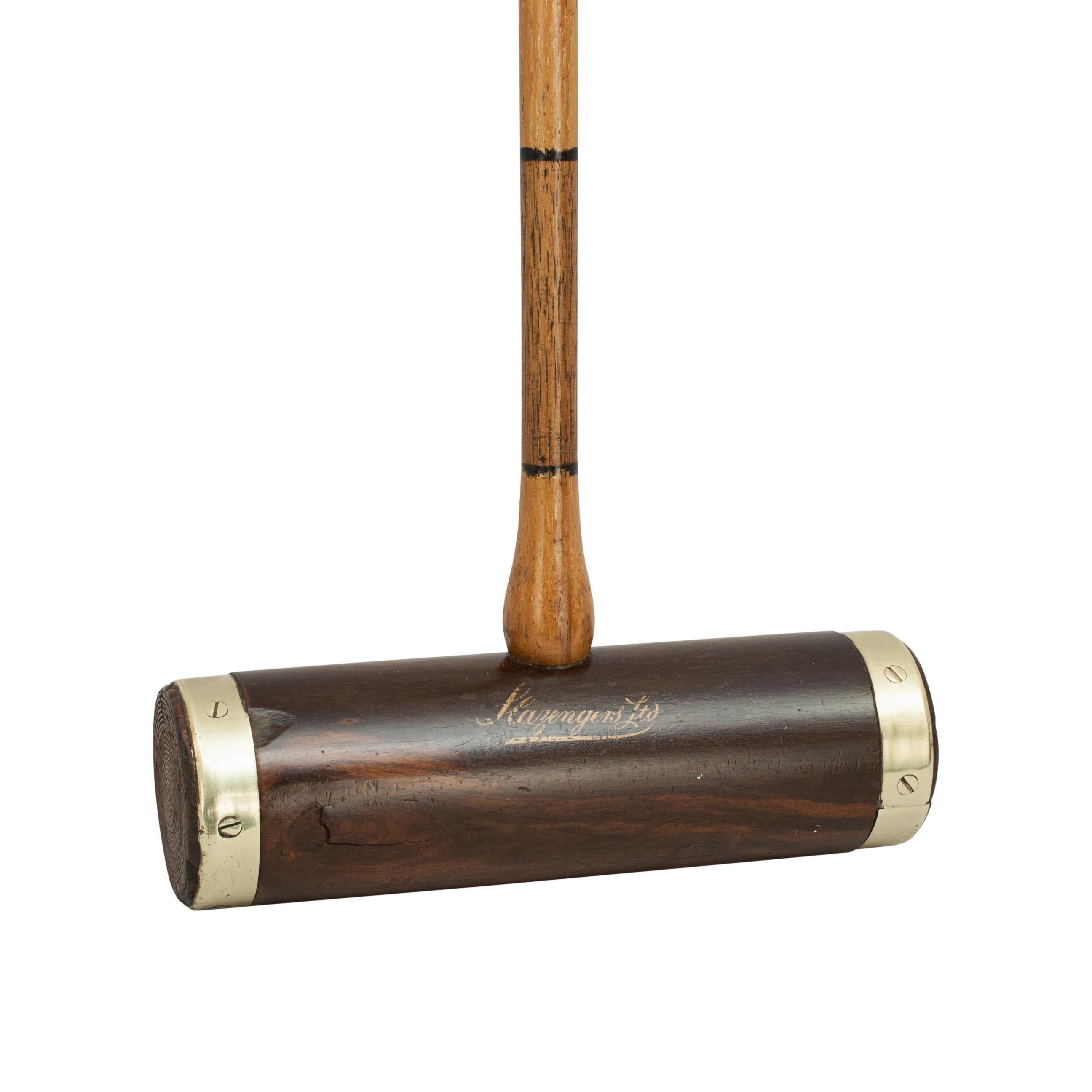 Antique Slazenger 'Corbally' croquet mallet.
A brass bound croquet mallet by Slazenger with a Lignum Vitae head. The mallet head has 'Slazengers Ltd' and 'The Corbally' written in gold on the side and it is fitted with an octagonal scored and