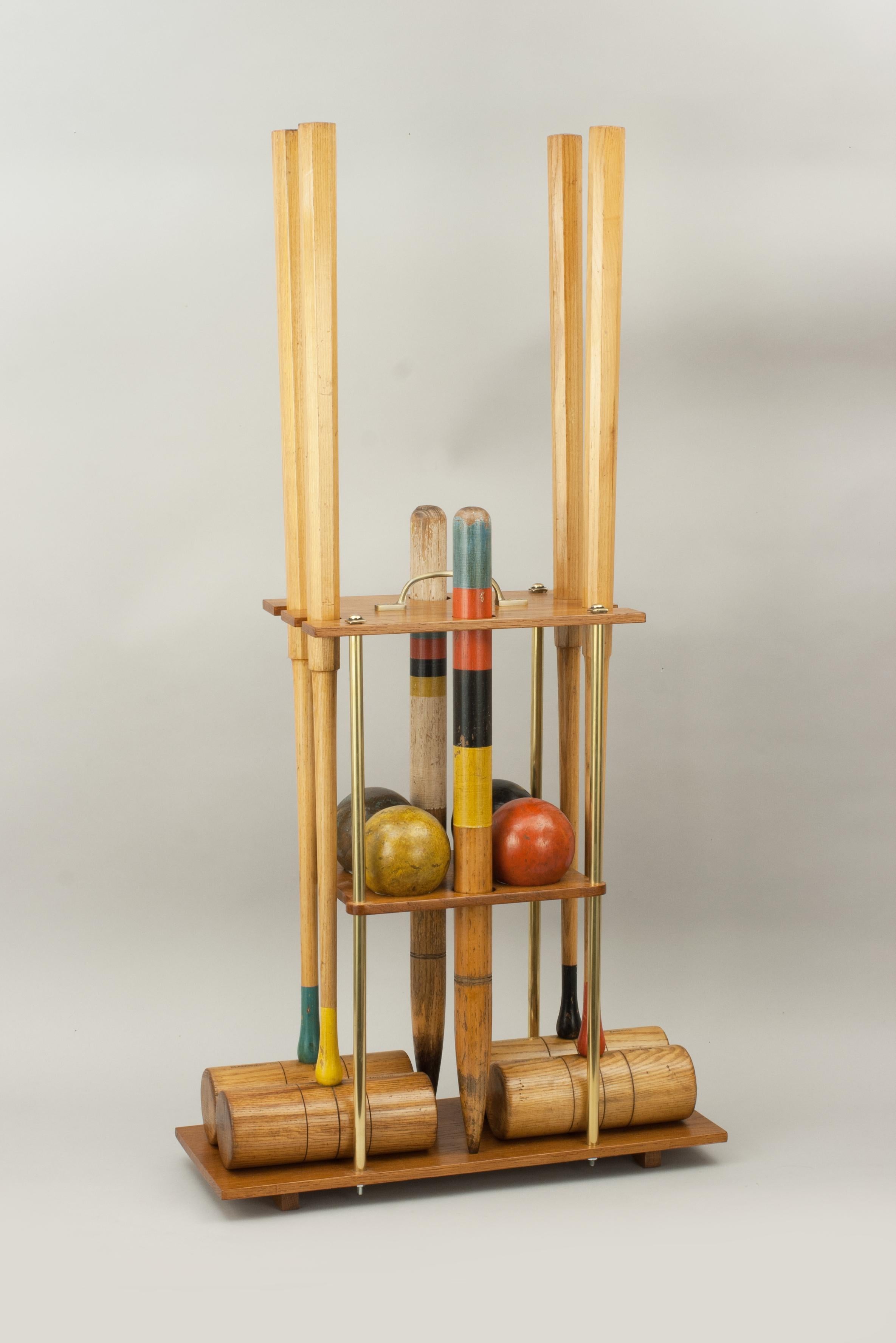 Ash croquet set by Slazenger on carry stand.
A fabulous Slazenger garden croquet set with four ash mallets on a new oak croquet carry stand. To complete the set there are four colored balls in the standard croquet colors, six bent metal hoops and