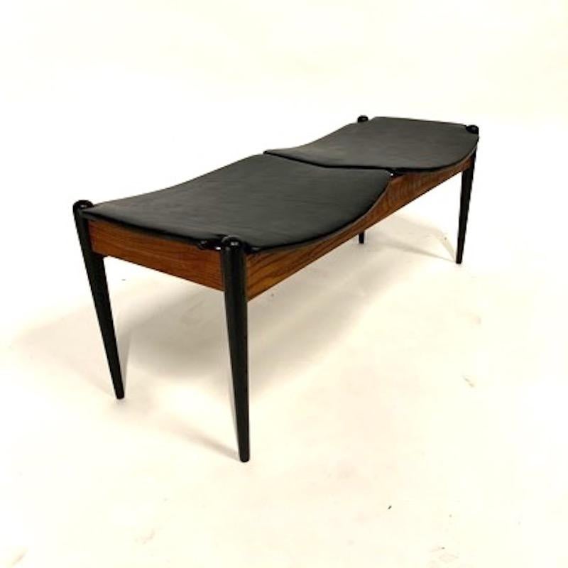 Great two-seat bench in ebonized and teak stained oak with freshly upholstered seats. Retailed by John Stuart in the 1960s.